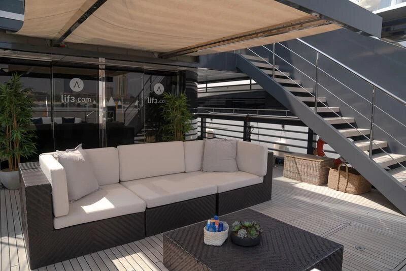a patio with a couch and a table aboard OCEAN SAPPHIRE Yacht for Sale