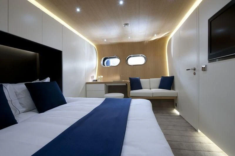 a room with a bed and a couch aboard OCEAN SAPPHIRE Yacht for Sale