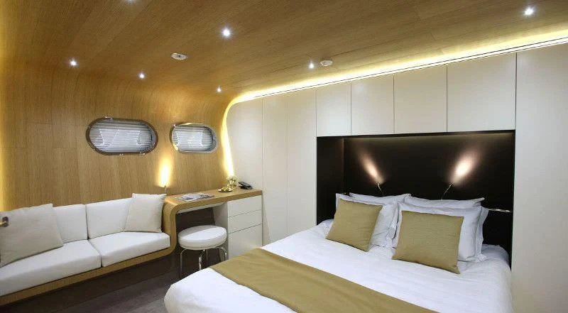 a room with a bed and a television aboard OCEAN SAPPHIRE Yacht for Sale
