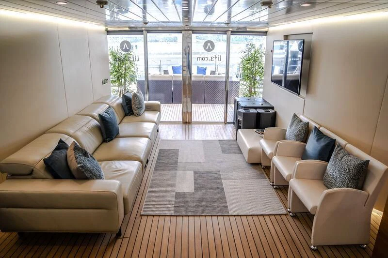 a living room with a large window aboard OCEAN SAPPHIRE Yacht for Sale