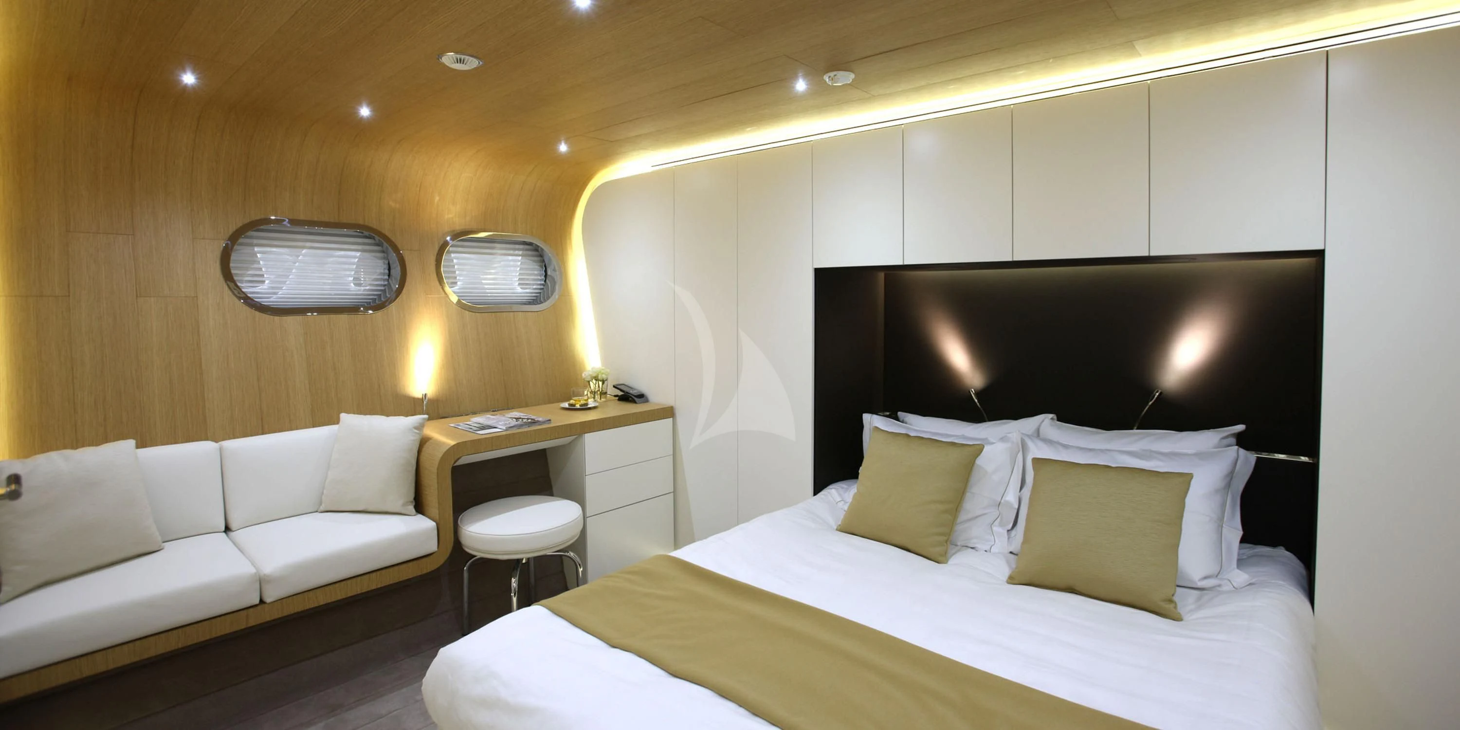 a room with a bed and a desk aboard OCEAN SAPPHIRE Yacht for Sale
