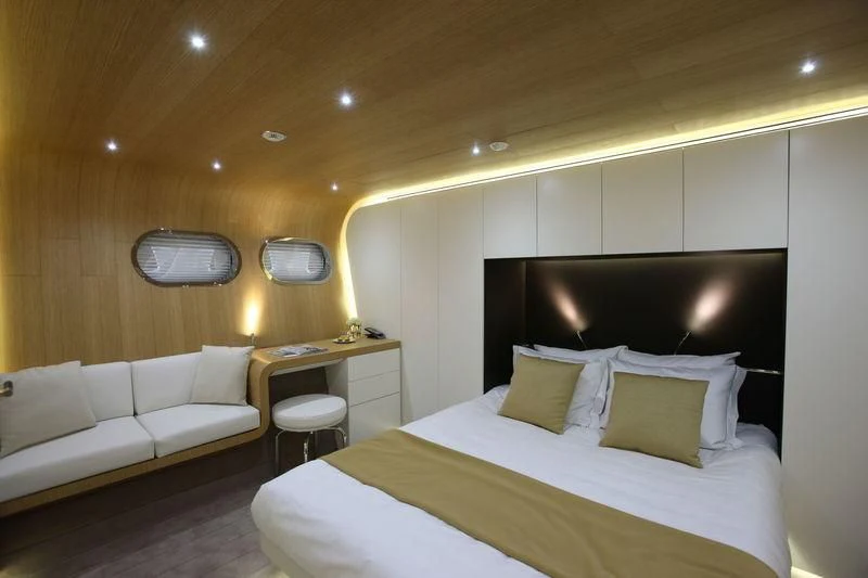 a room with a bed and a television aboard OCEAN SAPPHIRE Yacht for Sale