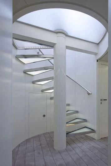 a room with a white ceiling and a wooden staircase aboard OCEAN SAPPHIRE Yacht for Sale