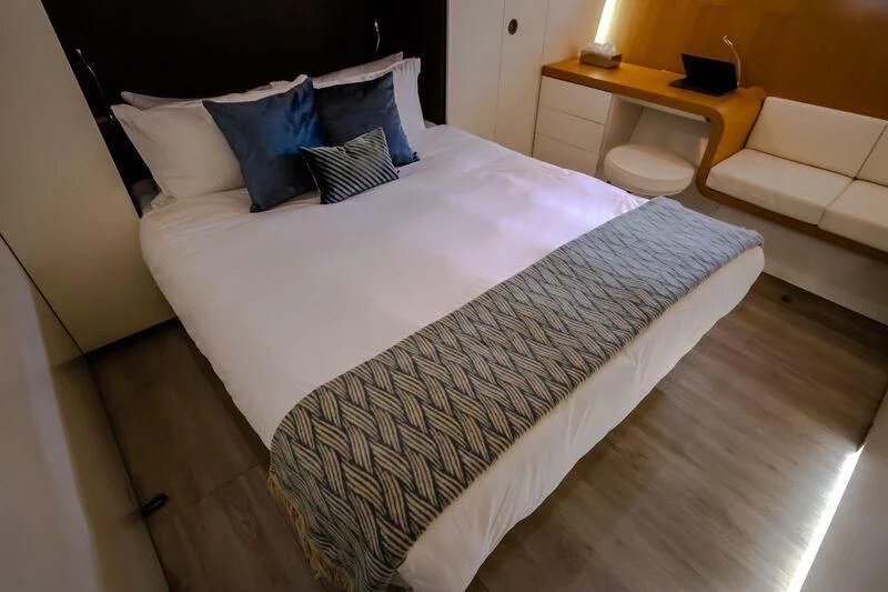 a bed with white sheets aboard OCEAN SAPPHIRE Yacht for Sale