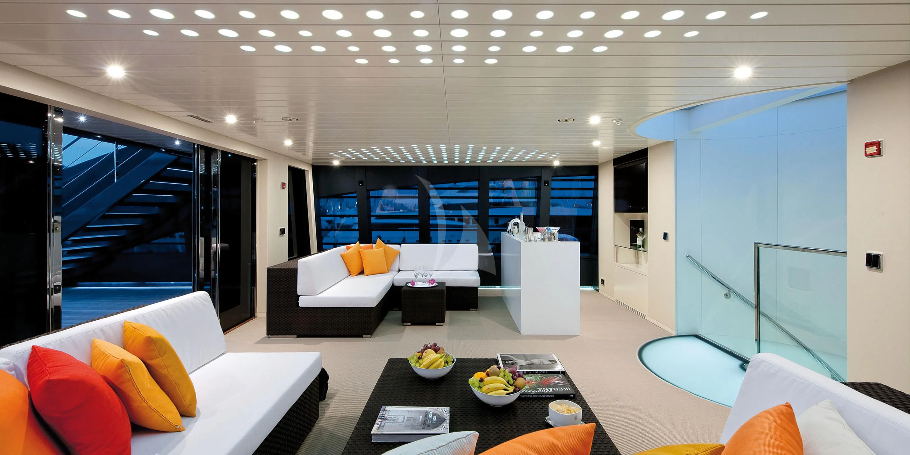 a modern living room with a large glass wall aboard OCEAN SAPPHIRE Yacht for Sale