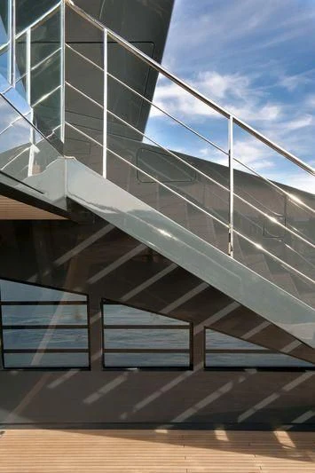 a wooden staircase with a railing aboard OCEAN SAPPHIRE Yacht for Sale