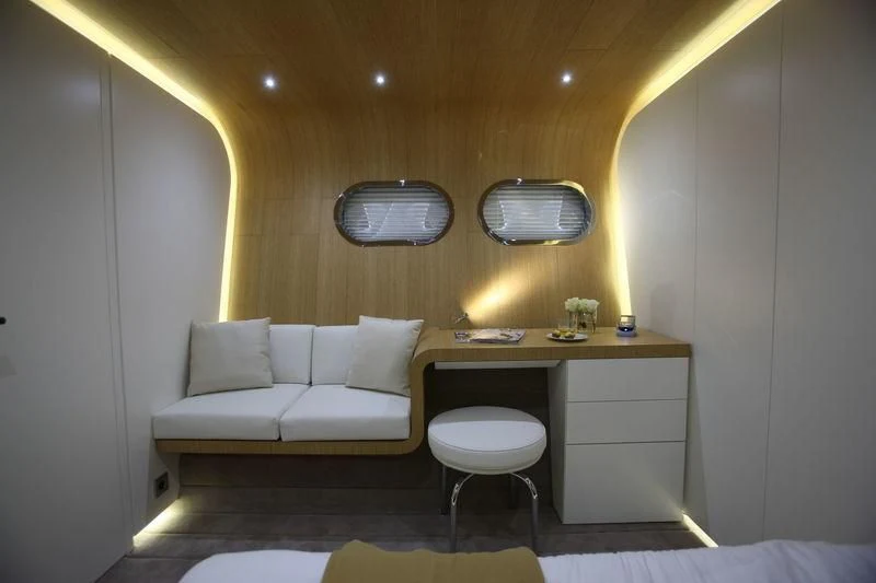 a room with a couch and a desk aboard OCEAN SAPPHIRE Yacht for Sale
