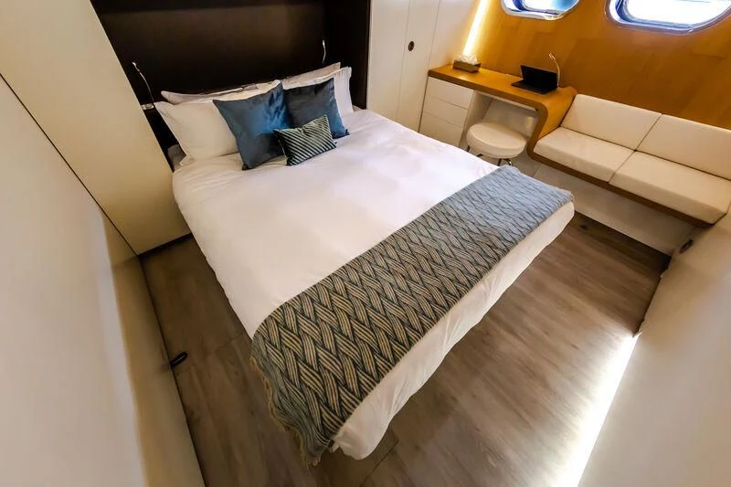 a bed with a white sheet aboard OCEAN SAPPHIRE Yacht for Sale