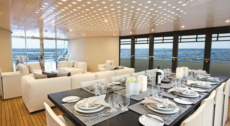 a table set with plates and glasses aboard OCEAN SAPPHIRE Yacht for Sale
