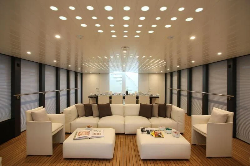 a large room with couches and a table aboard OCEAN SAPPHIRE Yacht for Sale