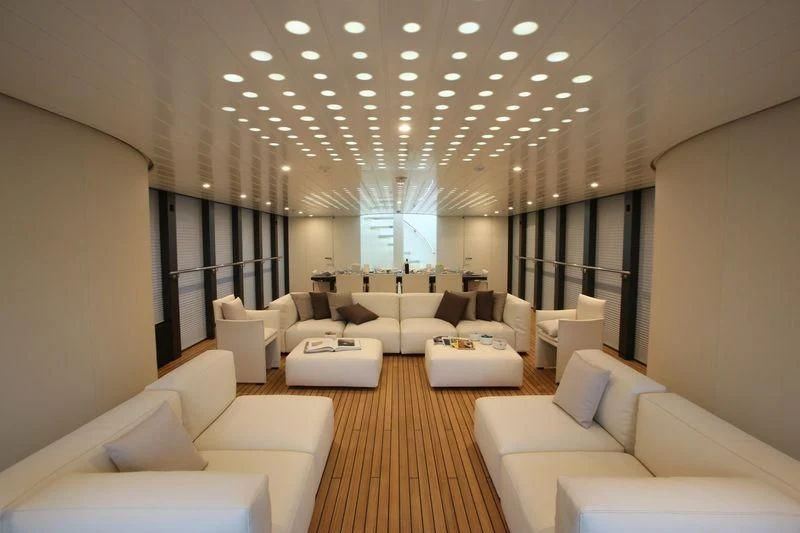 a large room with white couches aboard OCEAN SAPPHIRE Yacht for Sale