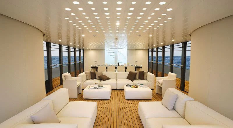 a living room with white couches aboard OCEAN SAPPHIRE Yacht for Sale