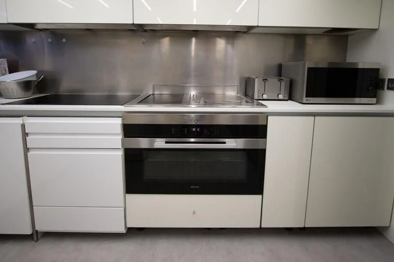 a kitchen with white cabinets aboard OCEAN SAPPHIRE Yacht for Sale