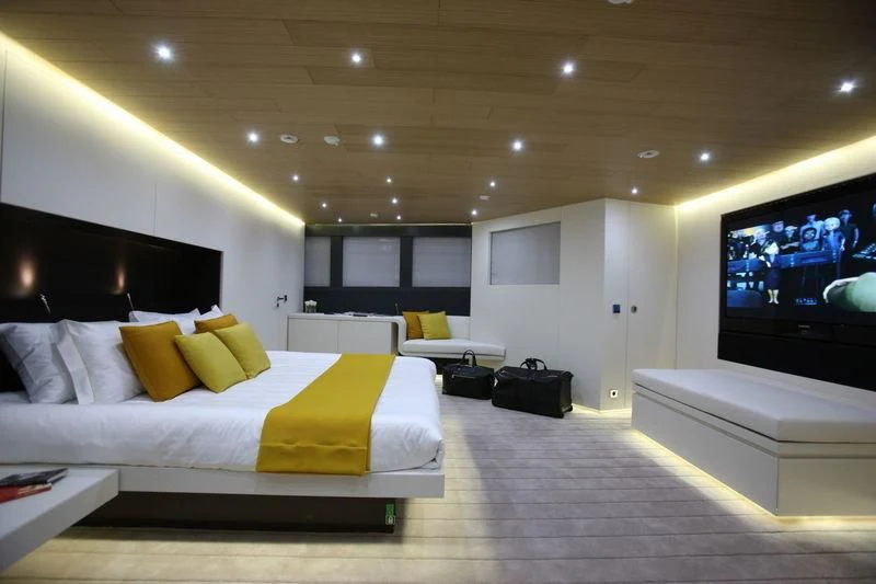 a room with a bed and a tv aboard OCEAN SAPPHIRE Yacht for Sale