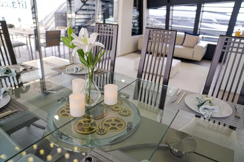 a table with candles and flowers aboard OCEAN SAPPHIRE Yacht for Sale