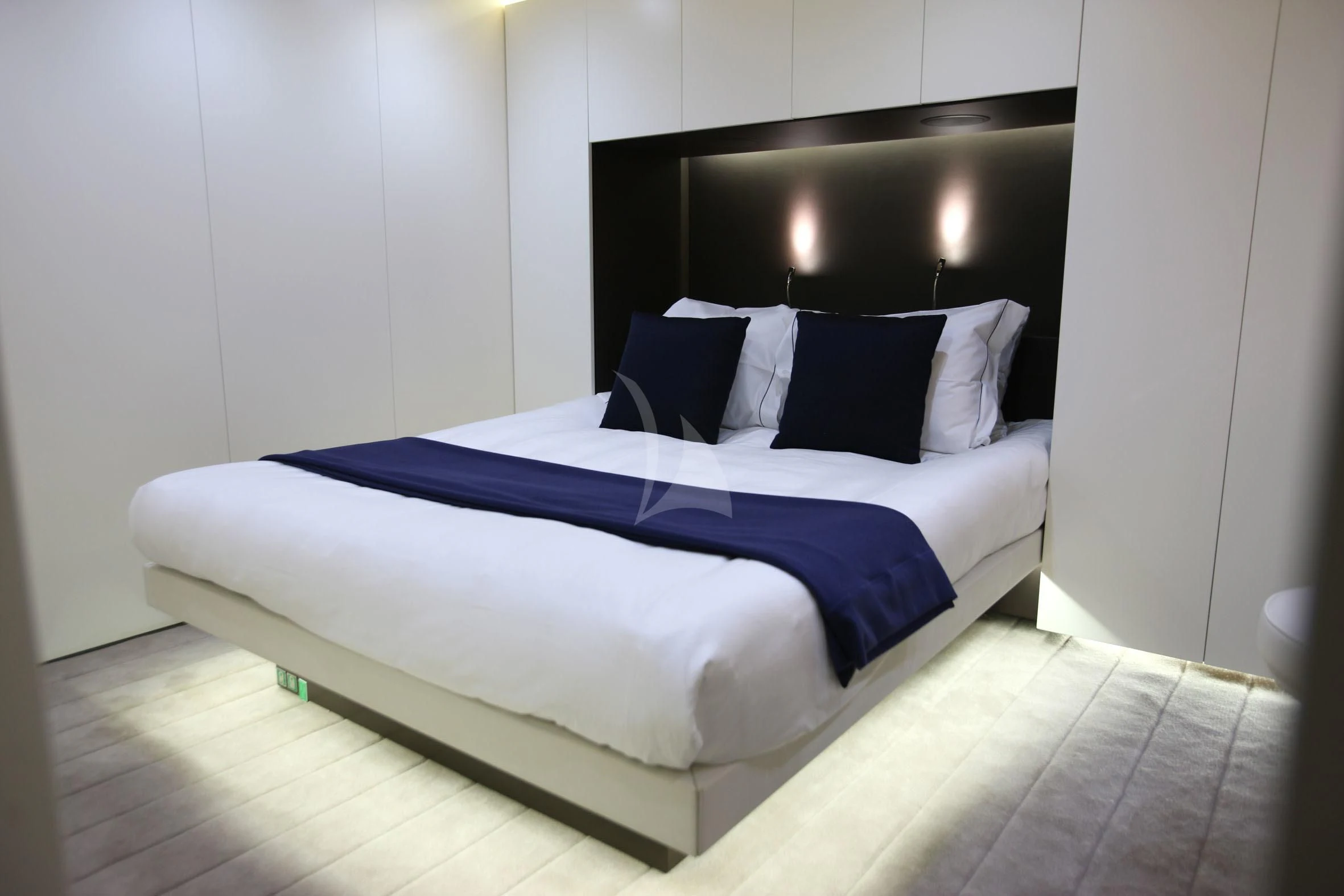 a bed with blue sheets aboard OCEAN SAPPHIRE Yacht for Sale