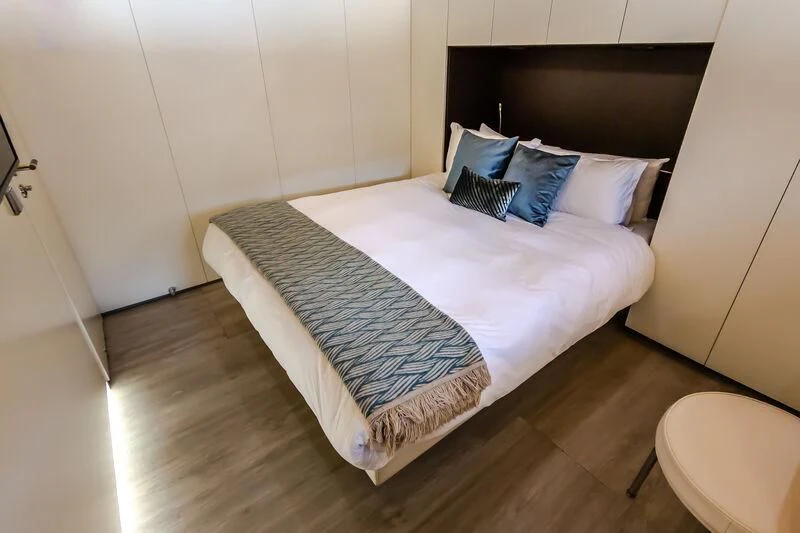 a bed with a white sheet and pillows on it aboard OCEAN SAPPHIRE Yacht for Sale