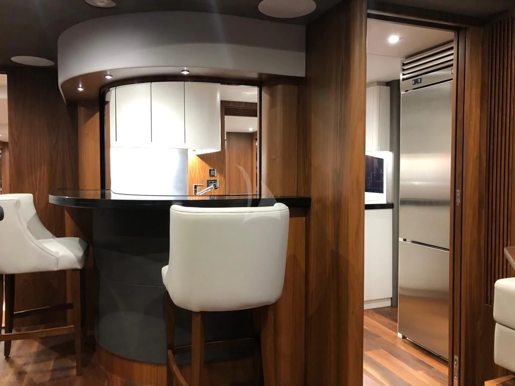 a kitchen with a table and chairs aboard BLACK MAMBA Yacht for Charter
