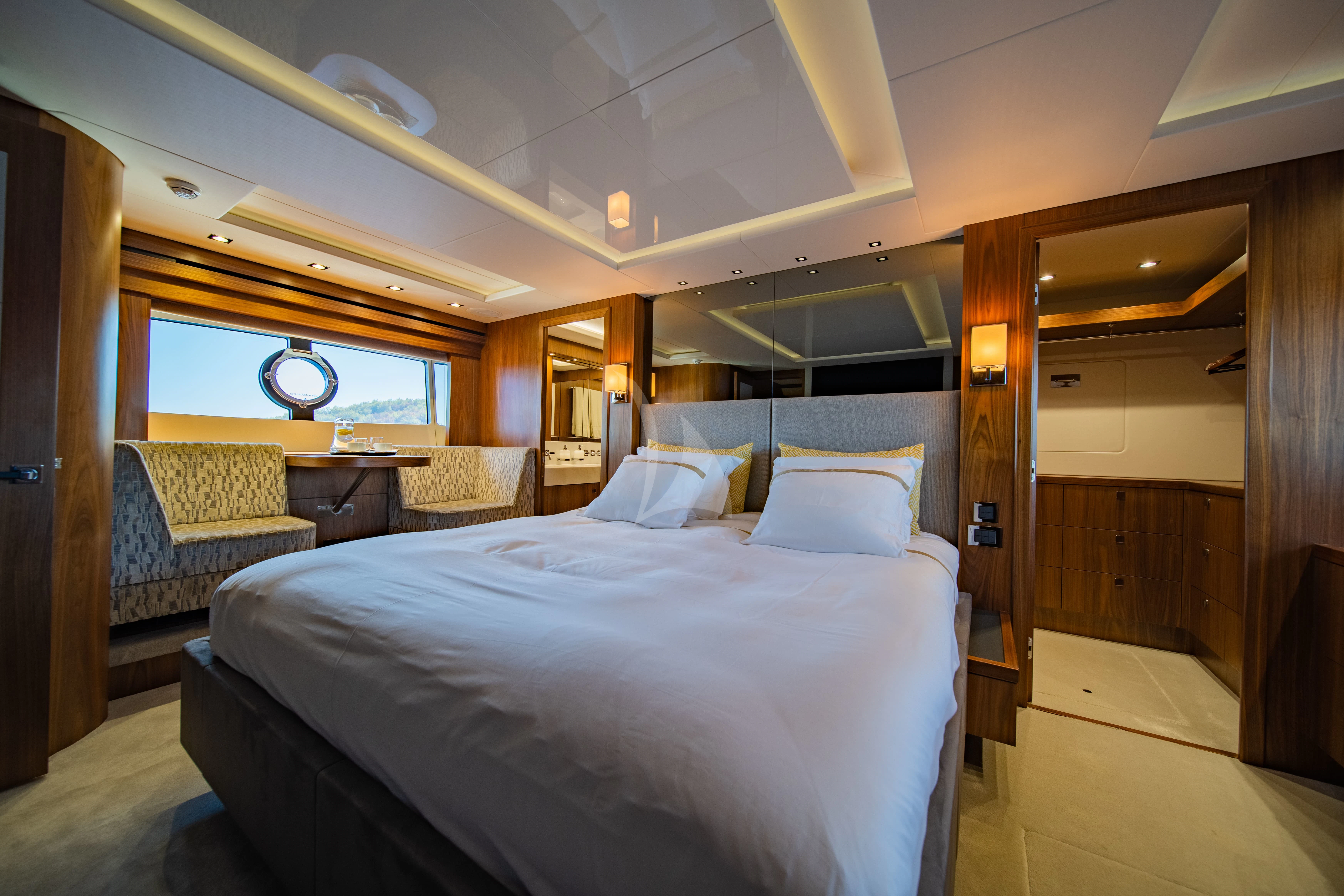 a room with a bed and a chair aboard BLACK MAMBA Yacht for Charter