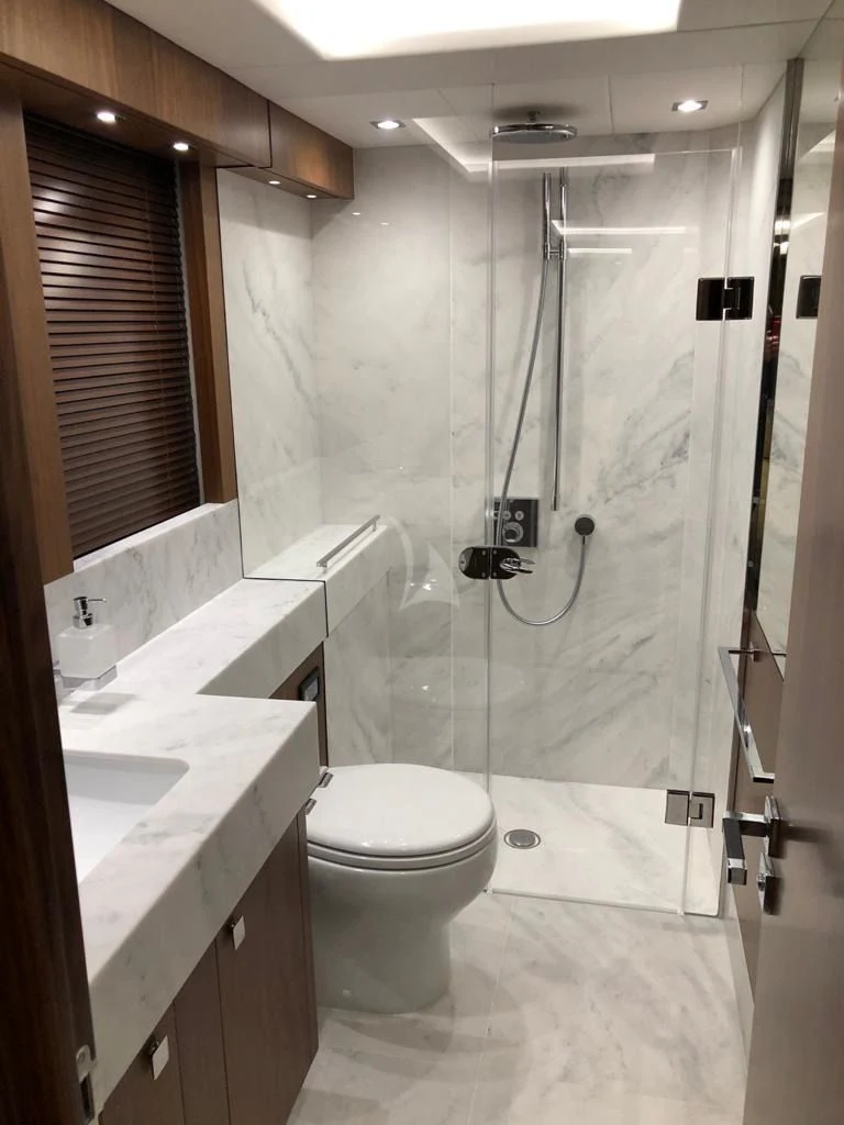a bathroom with a shower unit and toilet aboard BLACK MAMBA Yacht for Charter