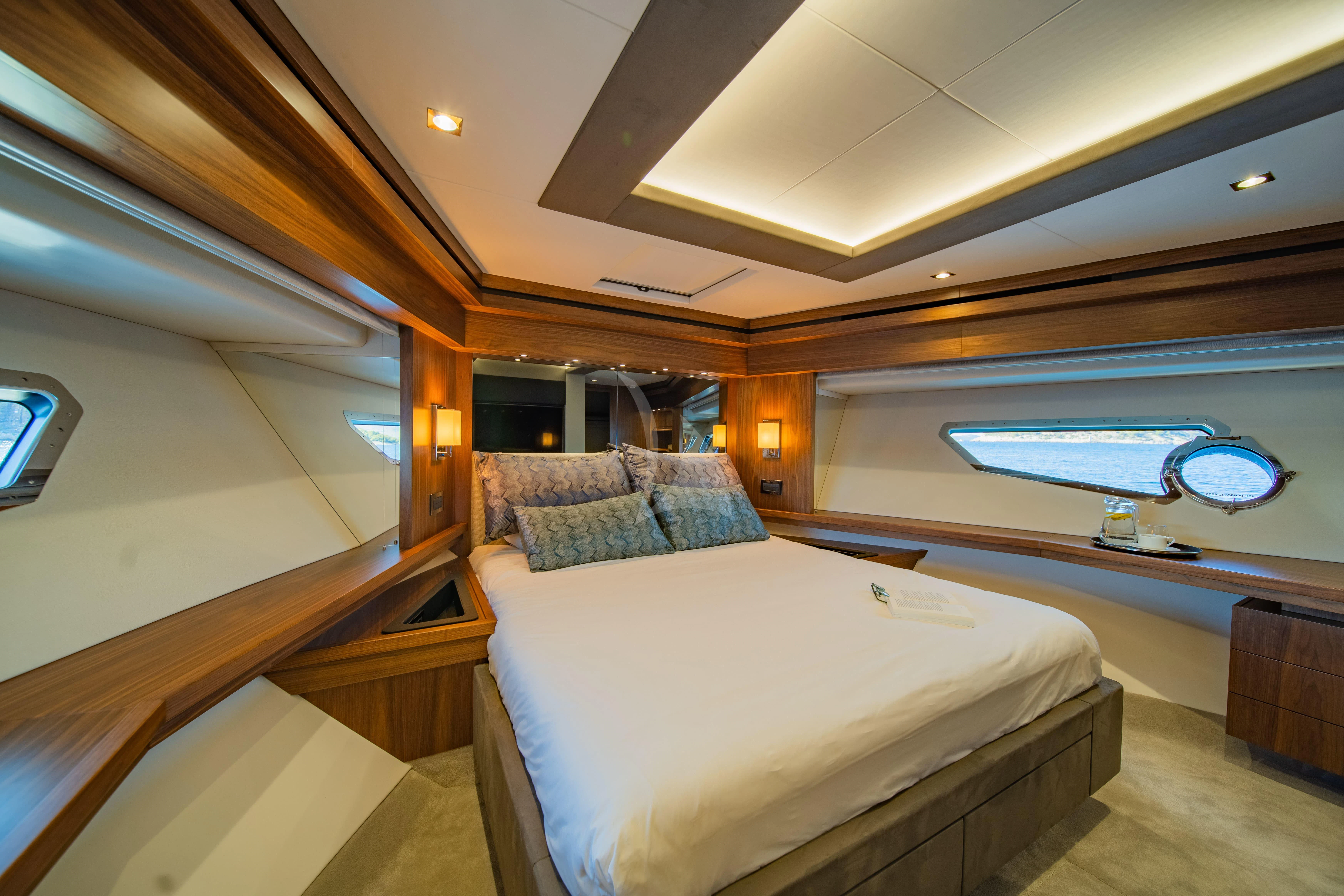 a room with a bed and a window aboard BLACK MAMBA Yacht for Charter