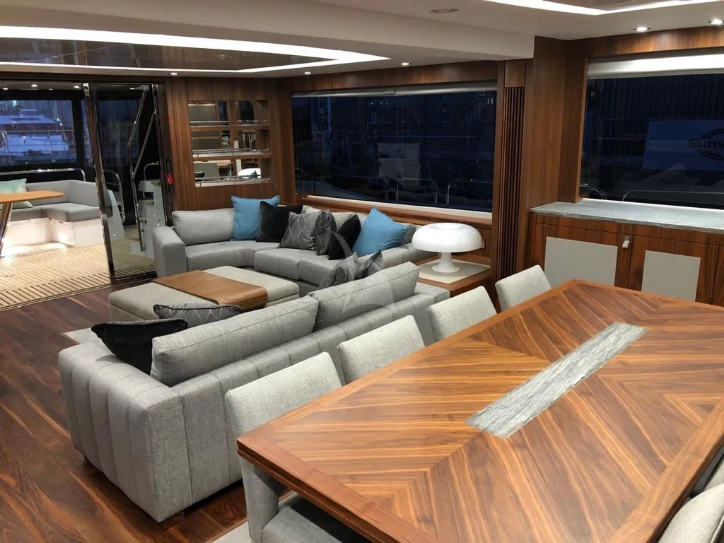a living room with a couch and a tv aboard BLACK MAMBA Yacht for Charter