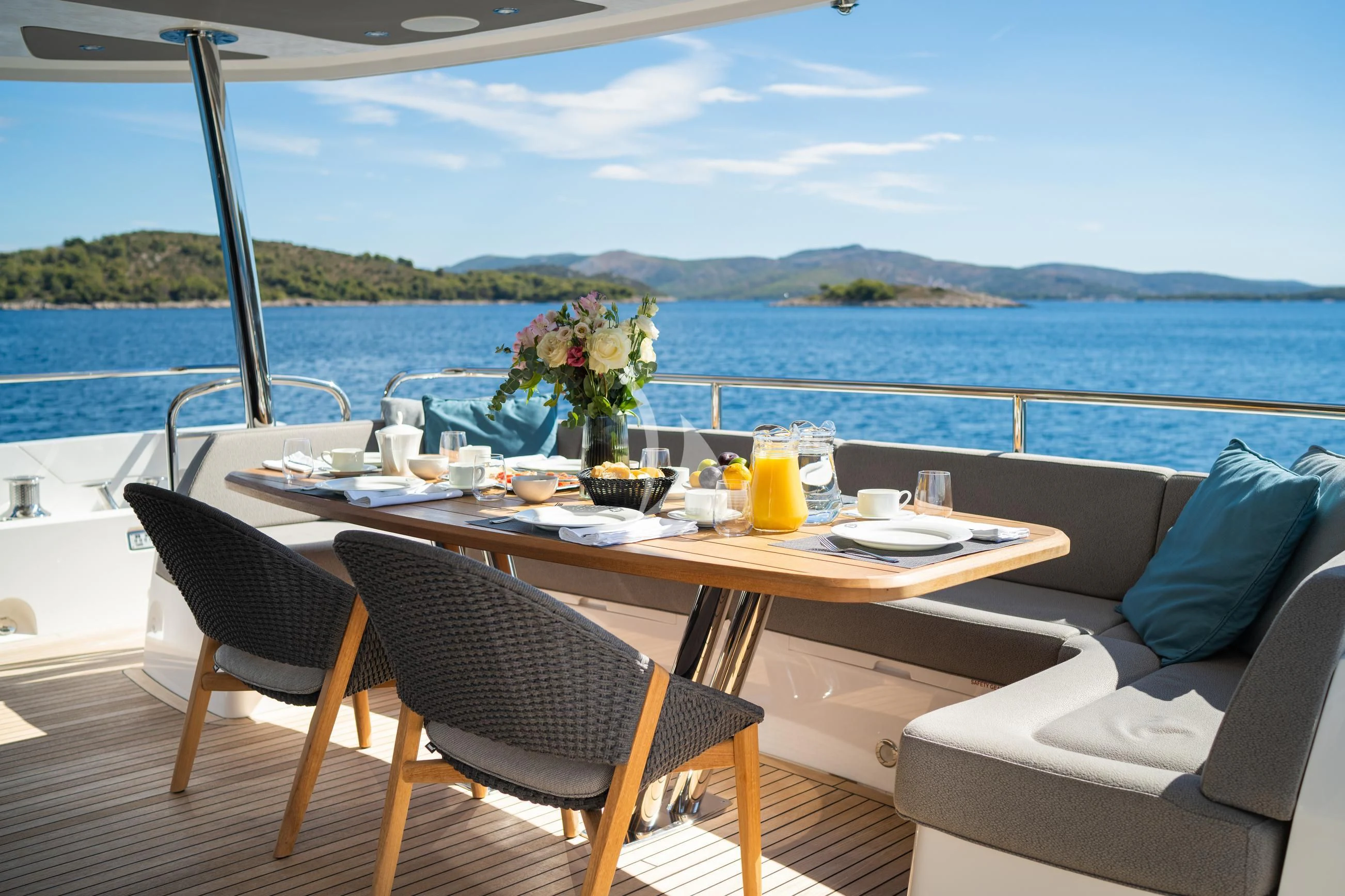 a table with chairs and a view of the ocean aboard BLACK MAMBA Yacht for Charter