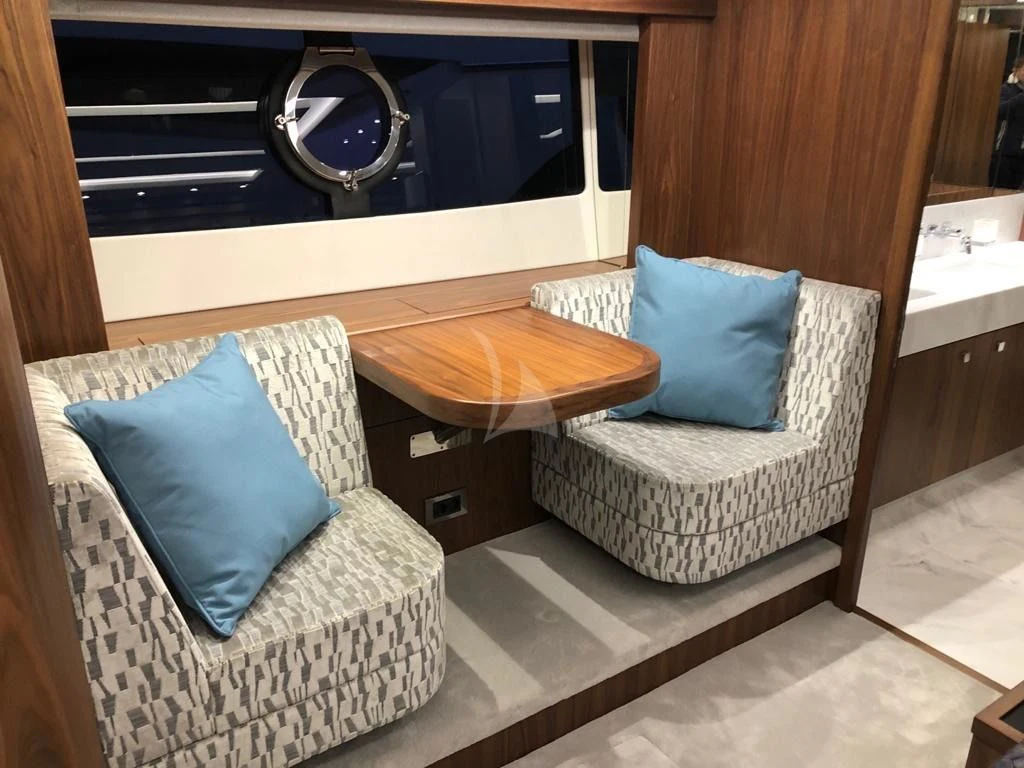 a chair and a couch in a room aboard BLACK MAMBA Yacht for Charter