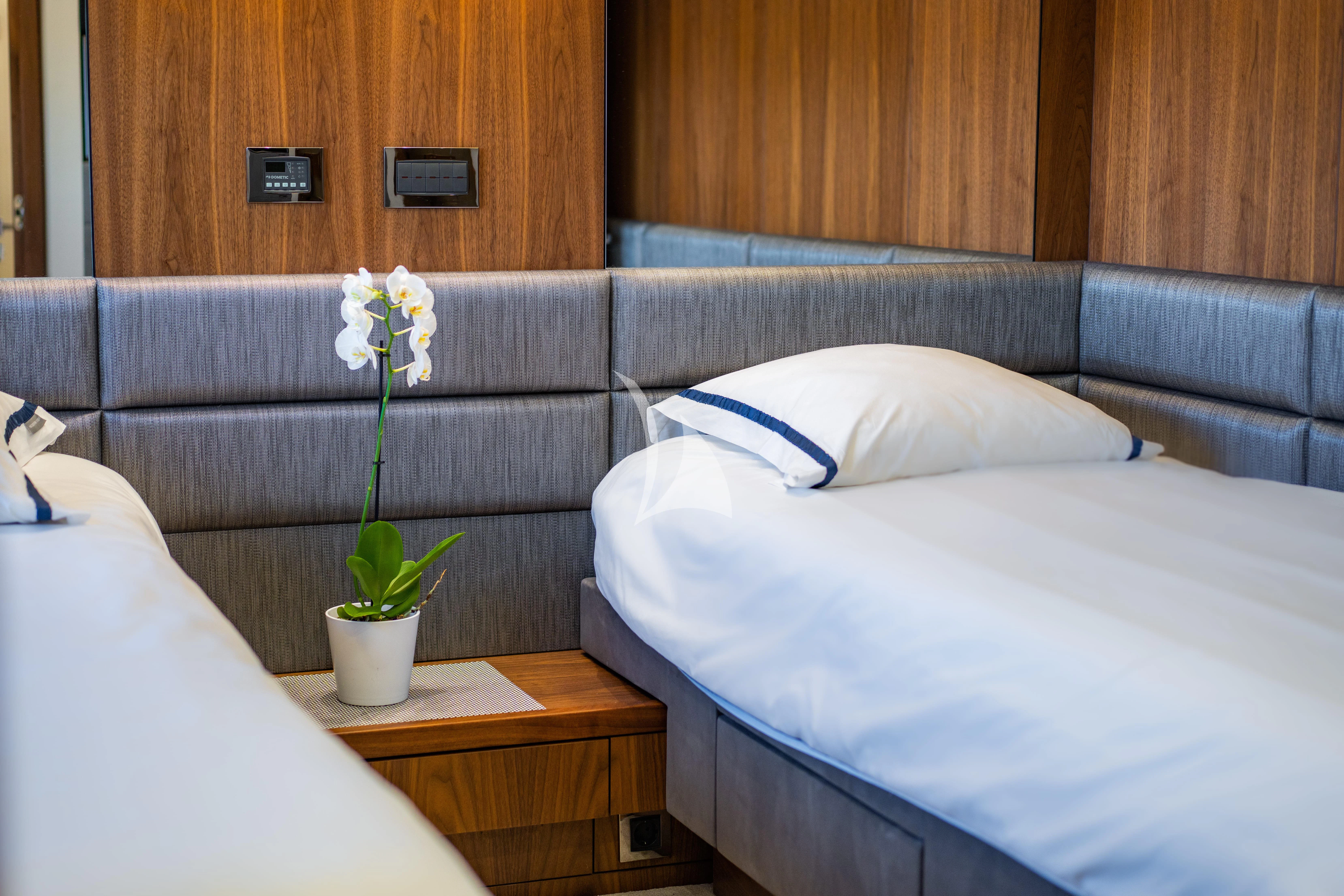 a bed with a white sheet and white pillows aboard BLACK MAMBA Yacht for Charter