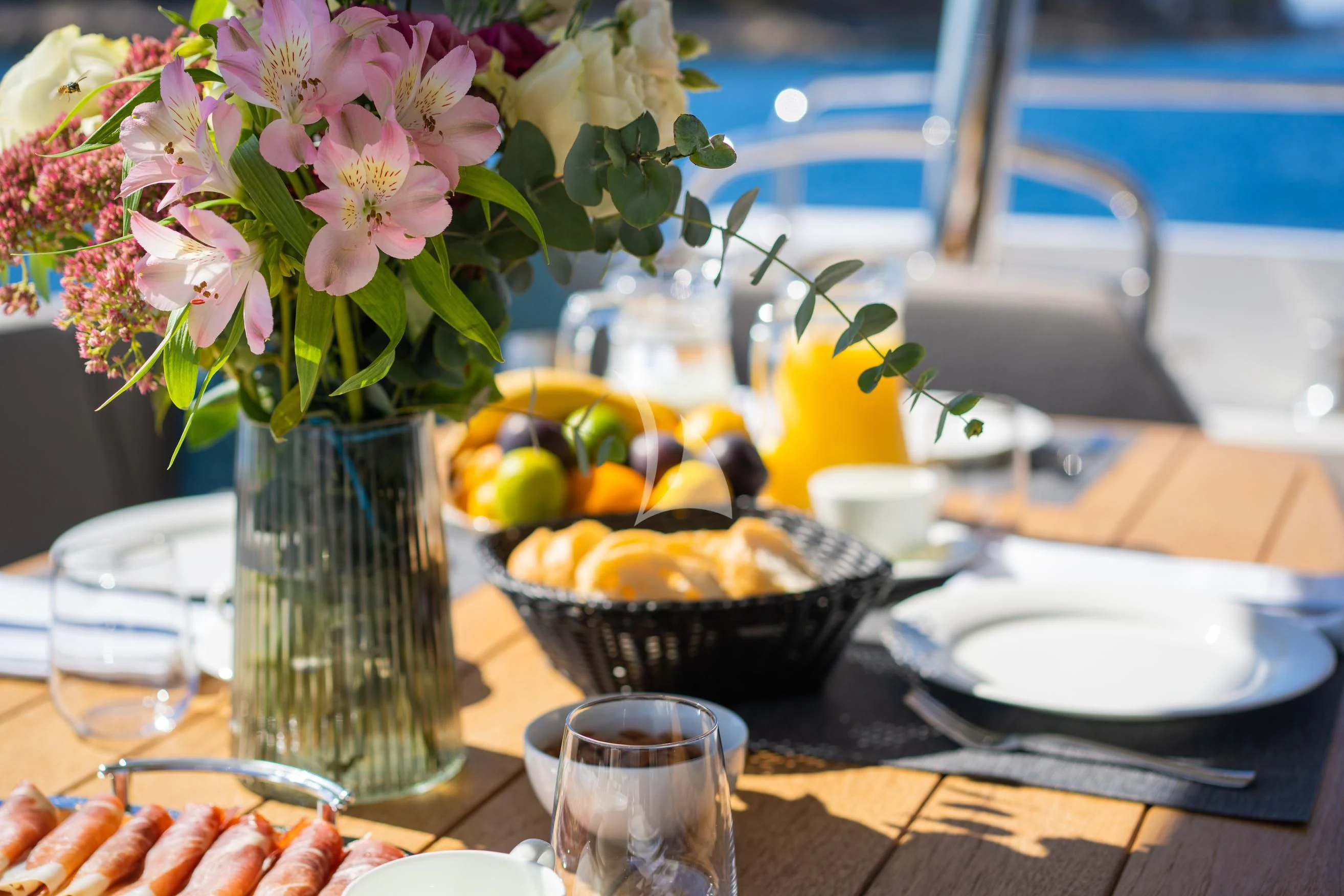 a vase of flowers next to a bowl of fruit aboard BLACK MAMBA Yacht for Charter