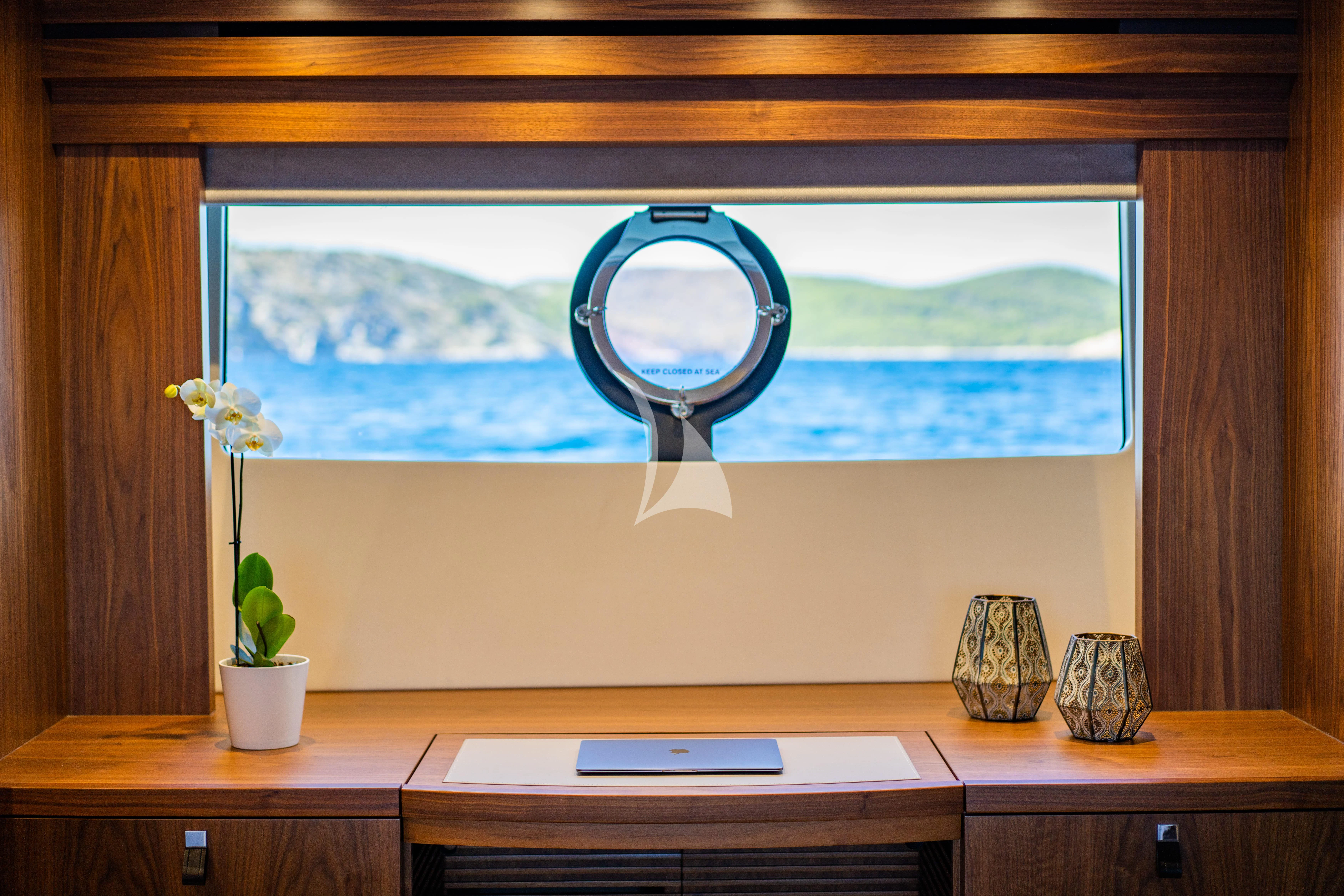 a desk with a mirror and a vase on it aboard BLACK MAMBA Yacht for Charter