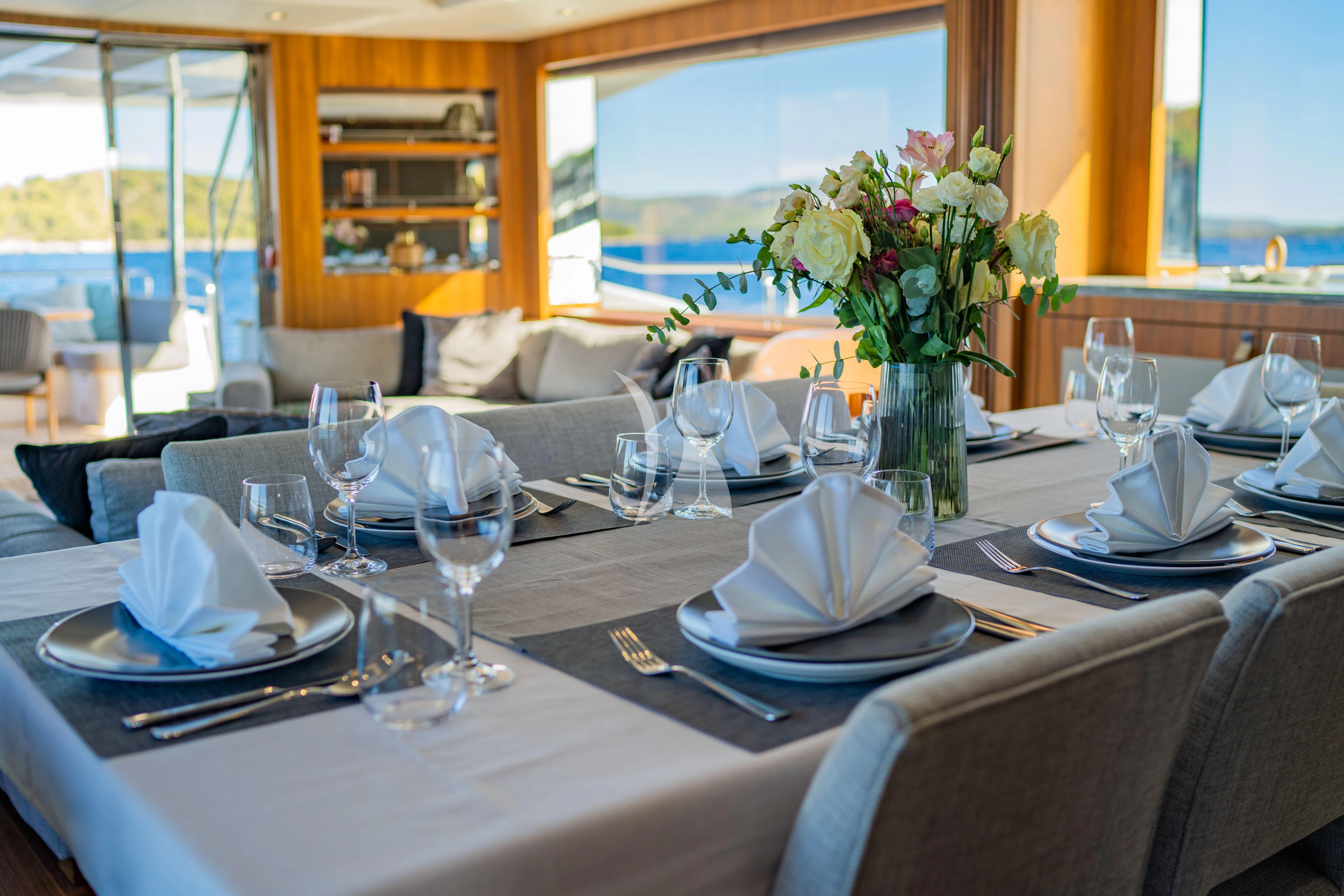 a table with plates and glasses aboard BLACK MAMBA Yacht for Charter