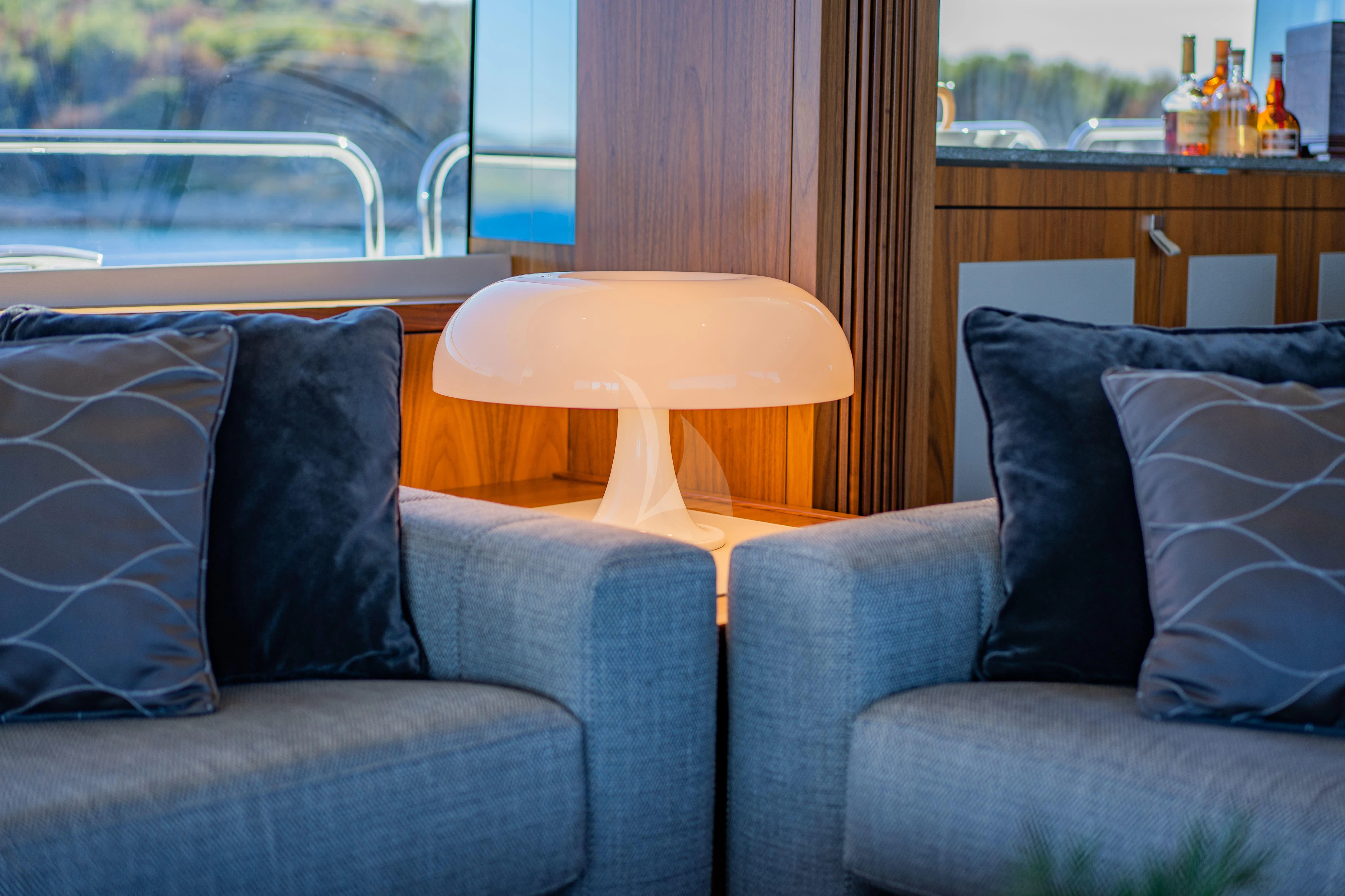 a living room with a couch and a table aboard BLACK MAMBA Yacht for Charter