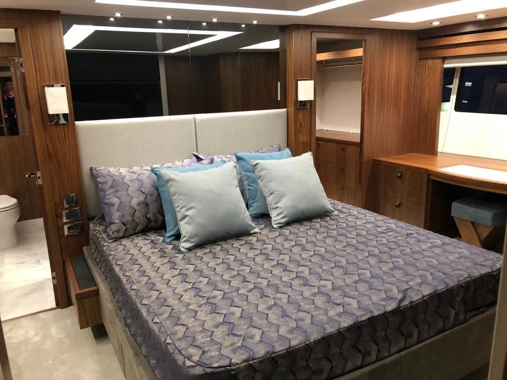 a bed with blue sheets aboard BLACK MAMBA Yacht for Charter