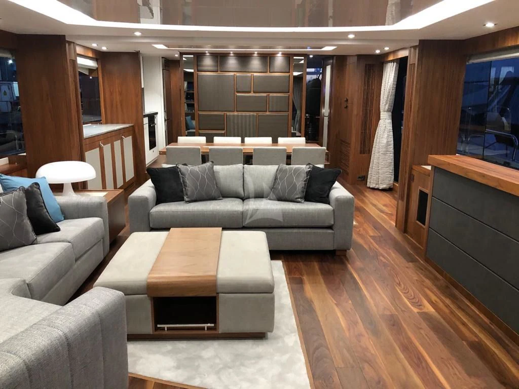 a living room with a couch and a table aboard BLACK MAMBA Yacht for Charter