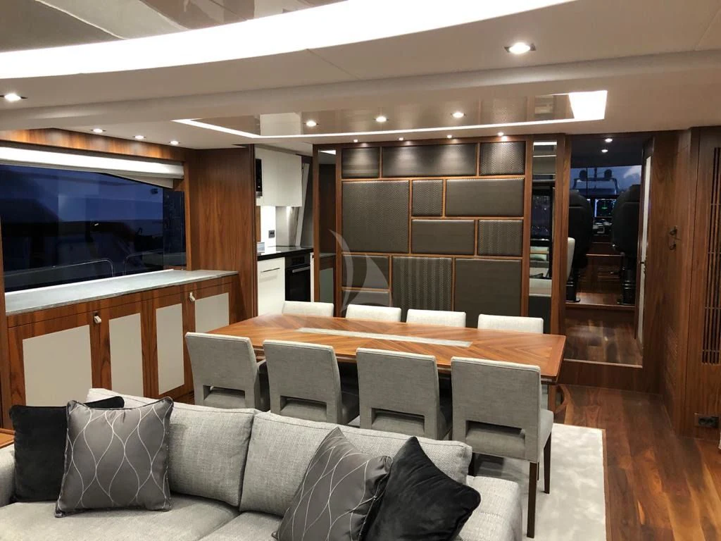 a room with a couch and a table and chairs aboard BLACK MAMBA Yacht for Charter
