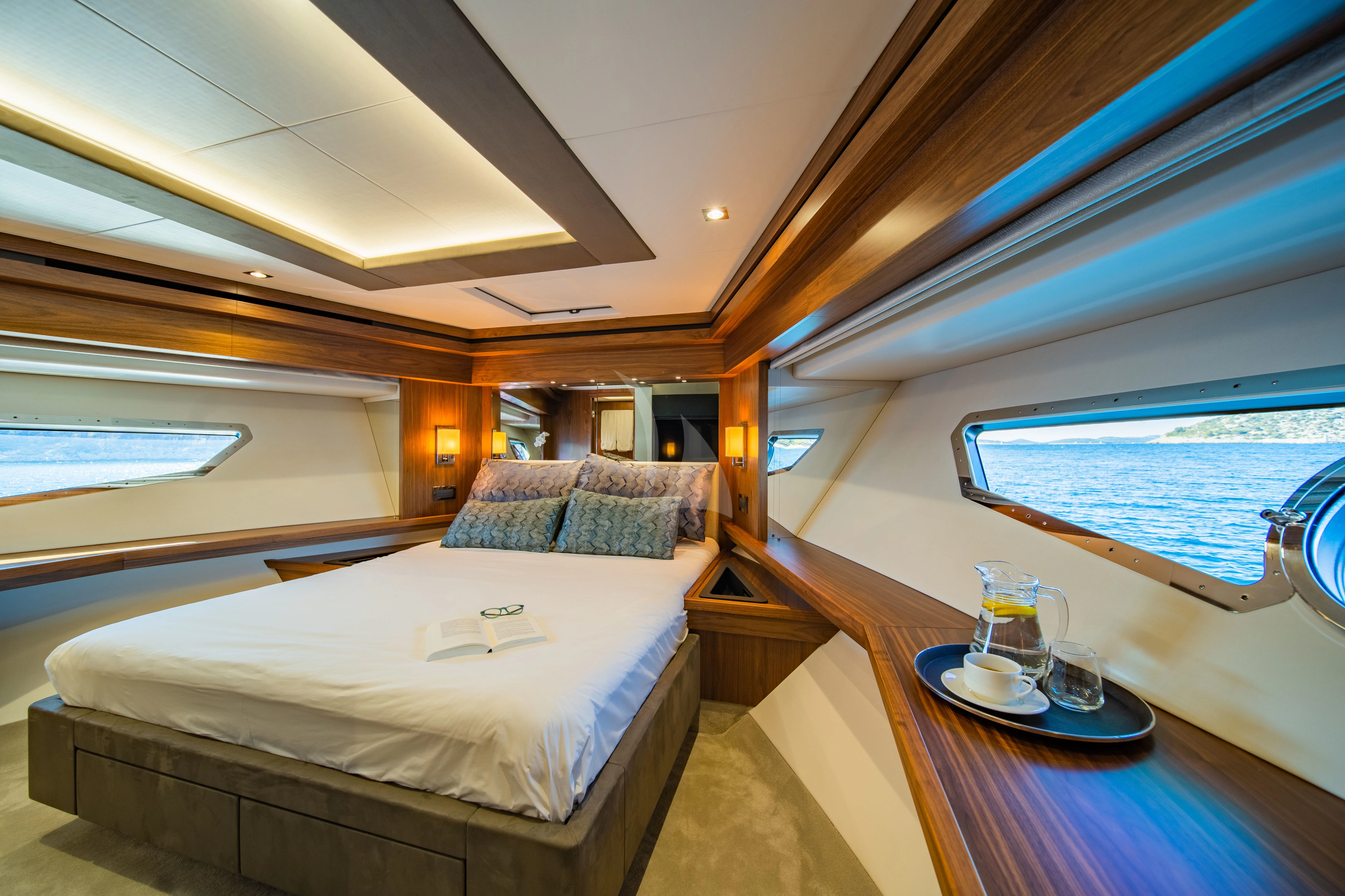 a room with a bed and a table aboard BLACK MAMBA Yacht for Charter