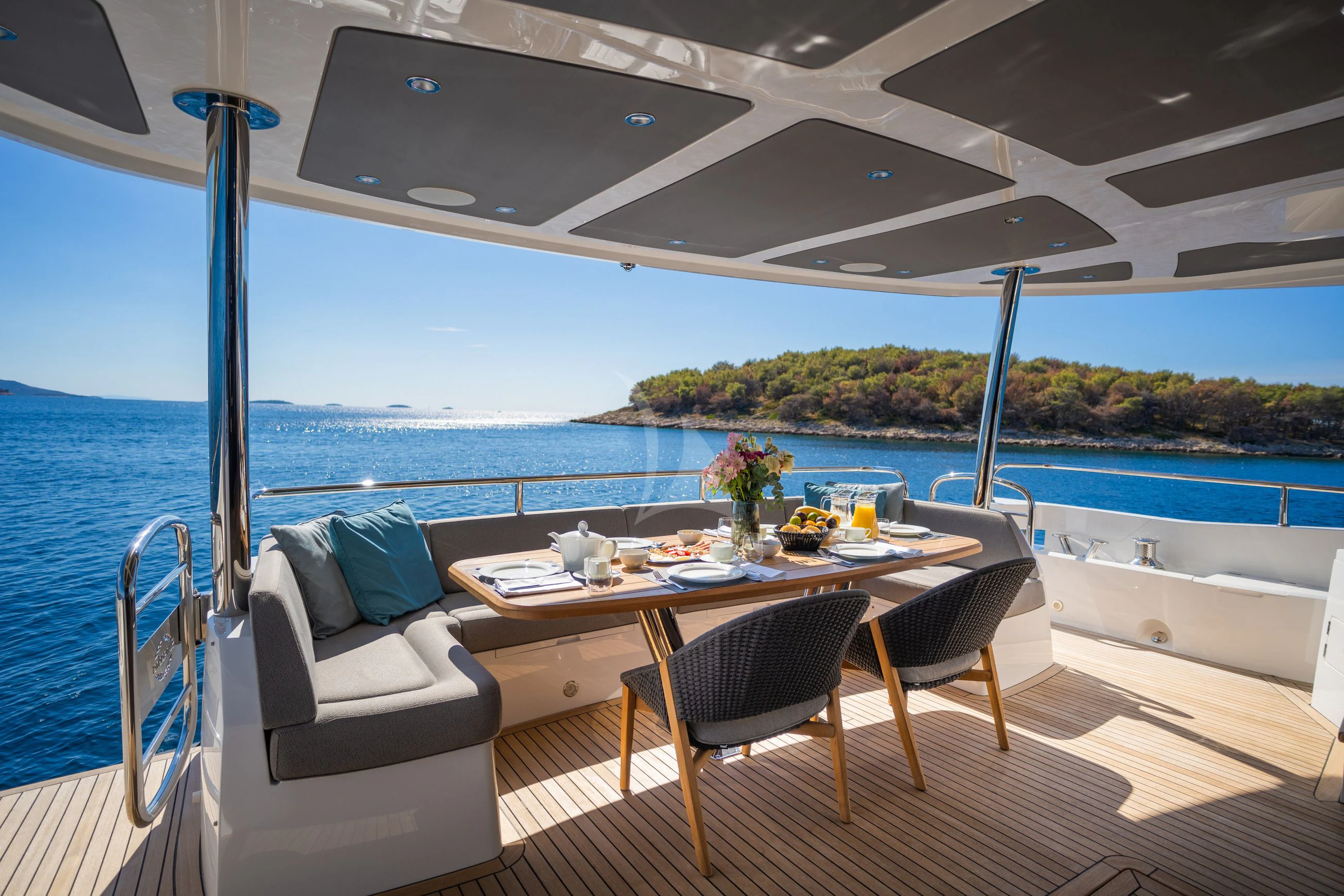a table and chairs on a boat aboard BLACK MAMBA Yacht for Charter