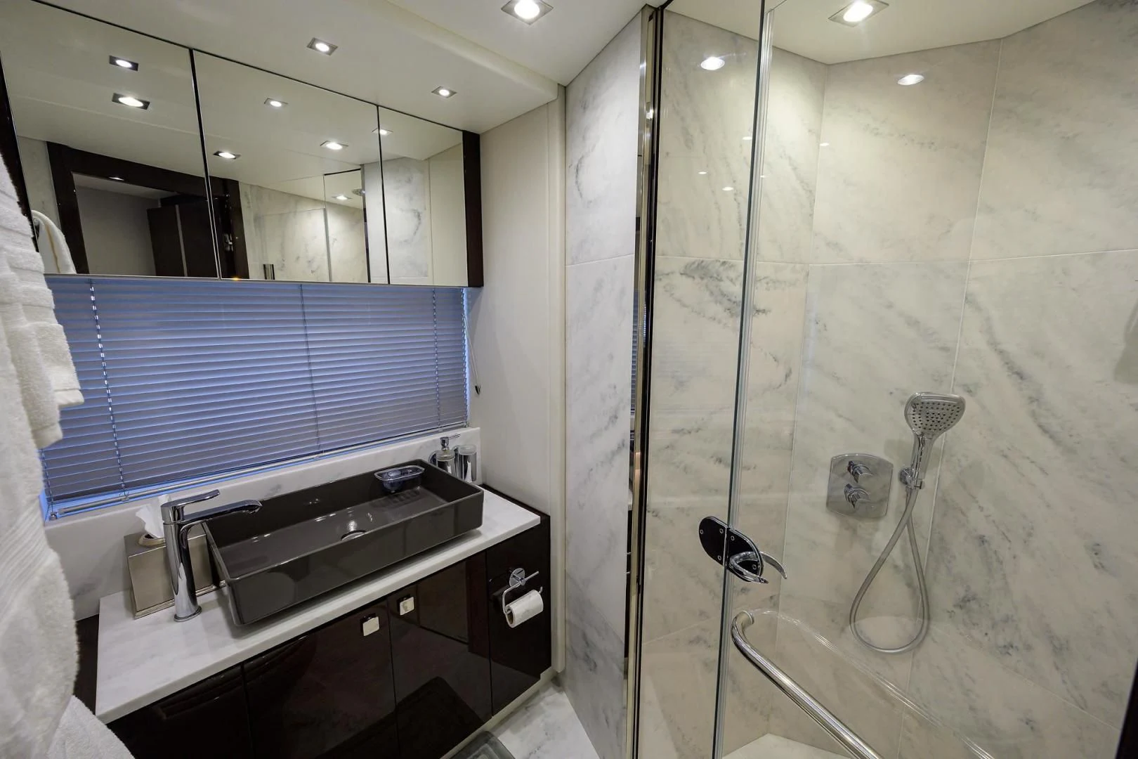 a bathroom with a glass shower aboard NIGHT STAR Yacht for Sale