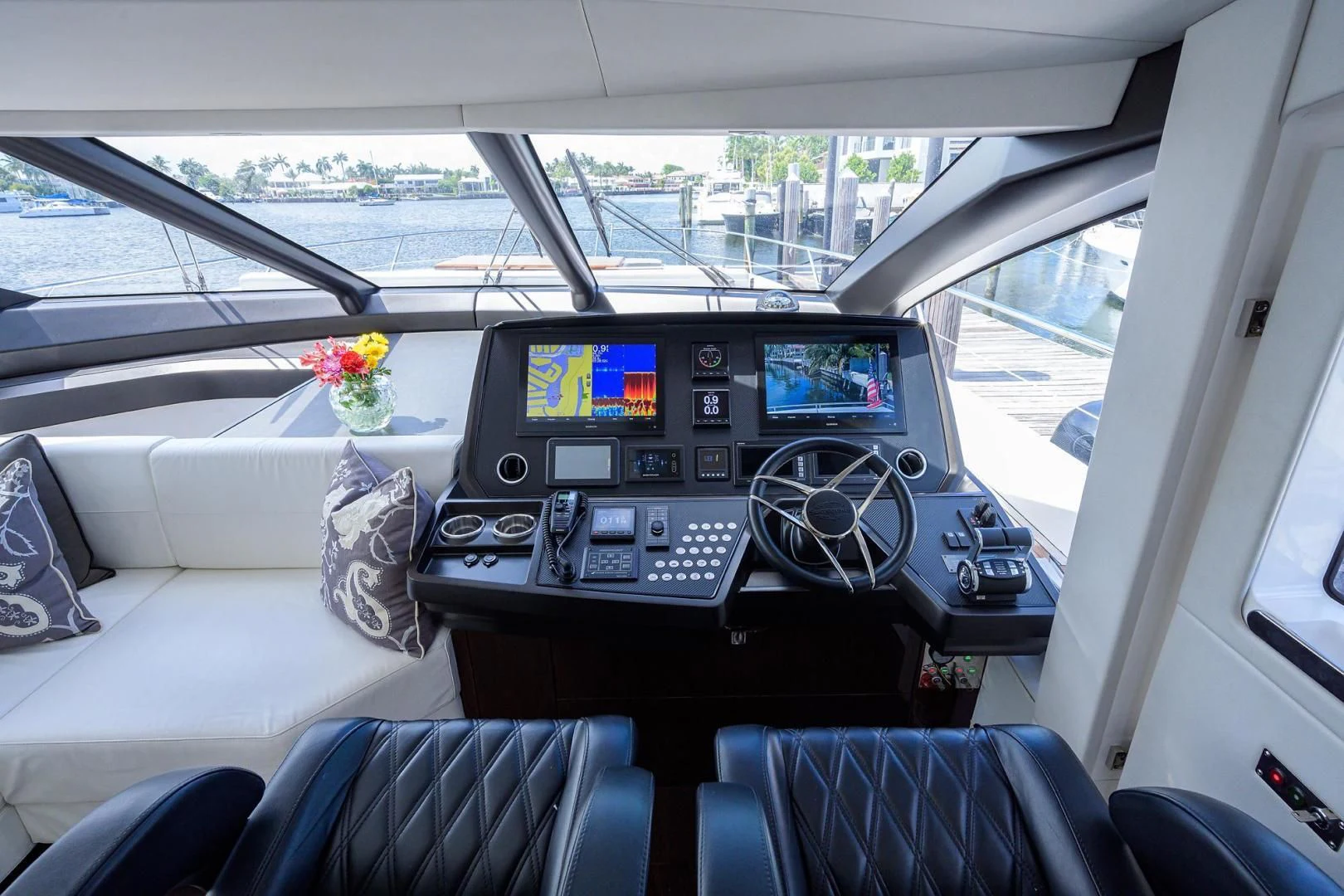 inside of a car with a screen and a keyboard and a flower on the dashboard aboard NIGHT STAR Yacht for Sale