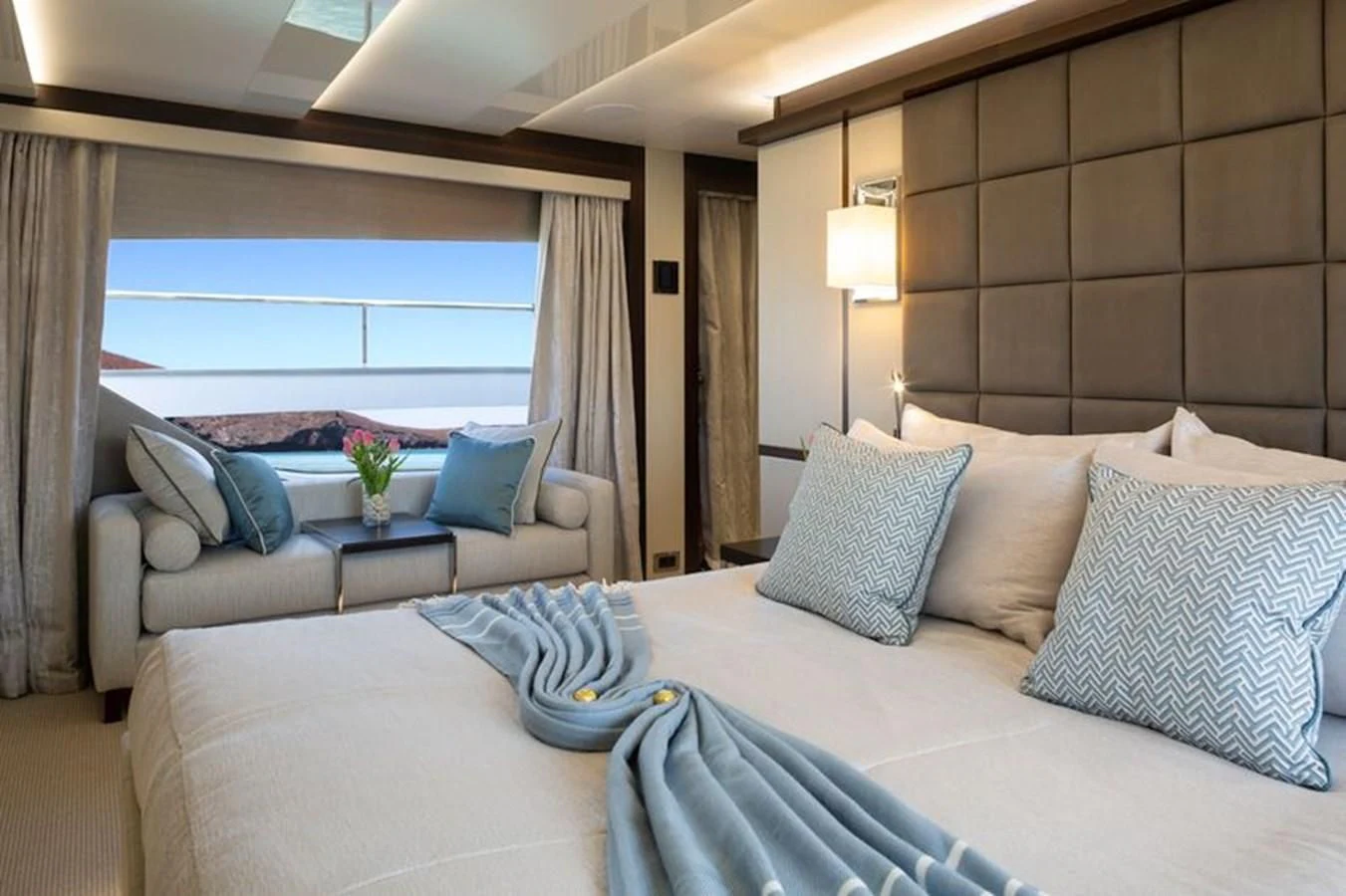 a bed with pillows and a table aboard MR K IRISTON Yacht for Sale