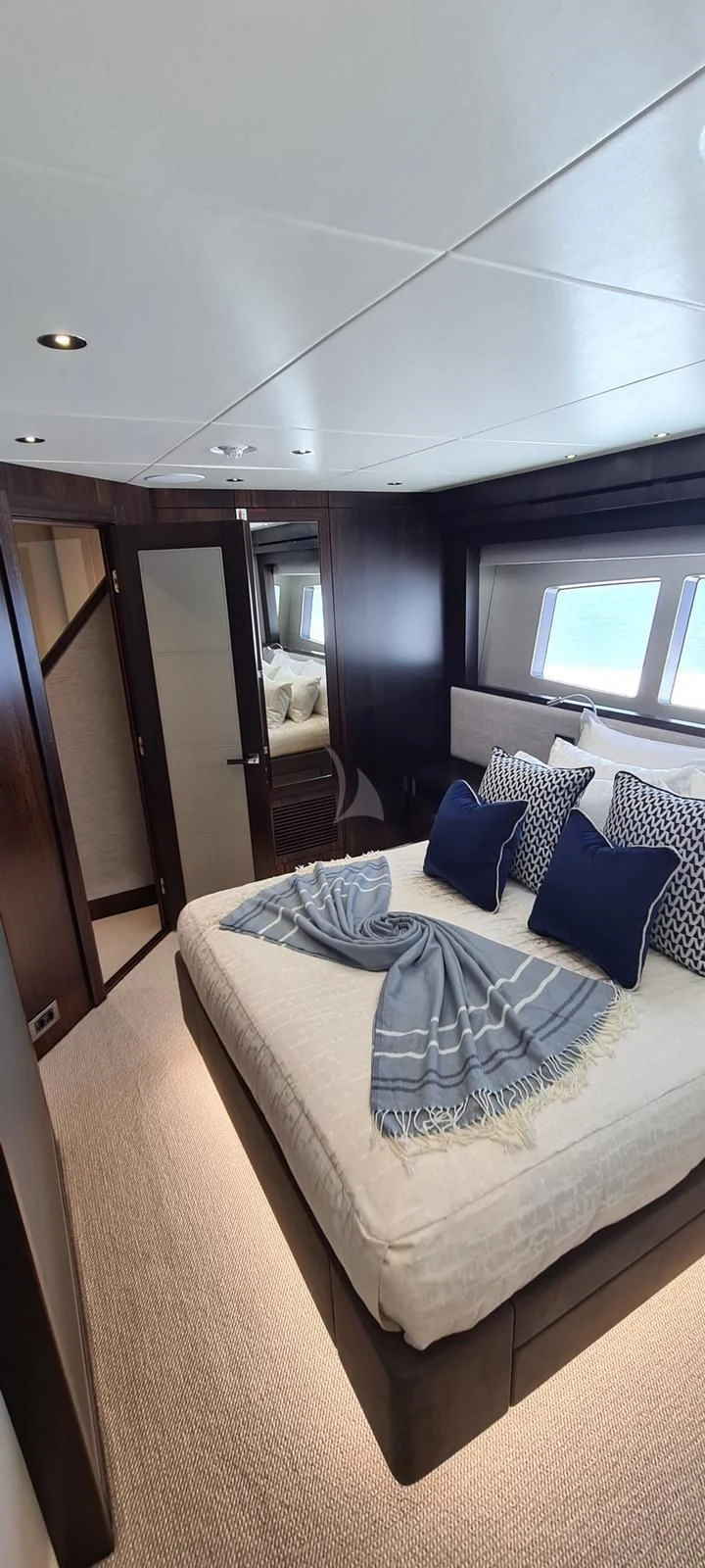 a bedroom with a bed and a mirror aboard MR K IRISTON Yacht for Sale