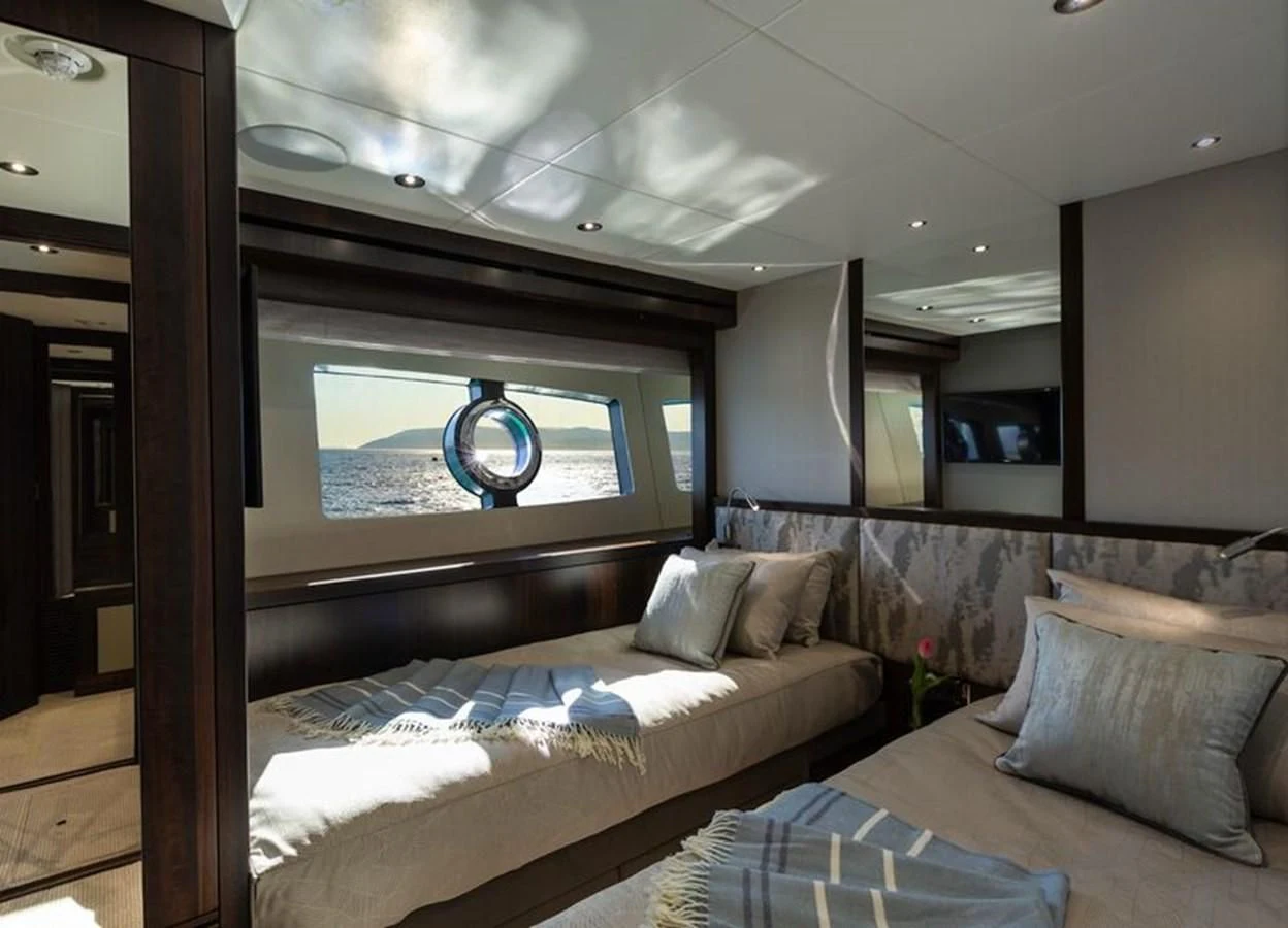 a room with a bed and a couch aboard MR K IRISTON Yacht for Sale