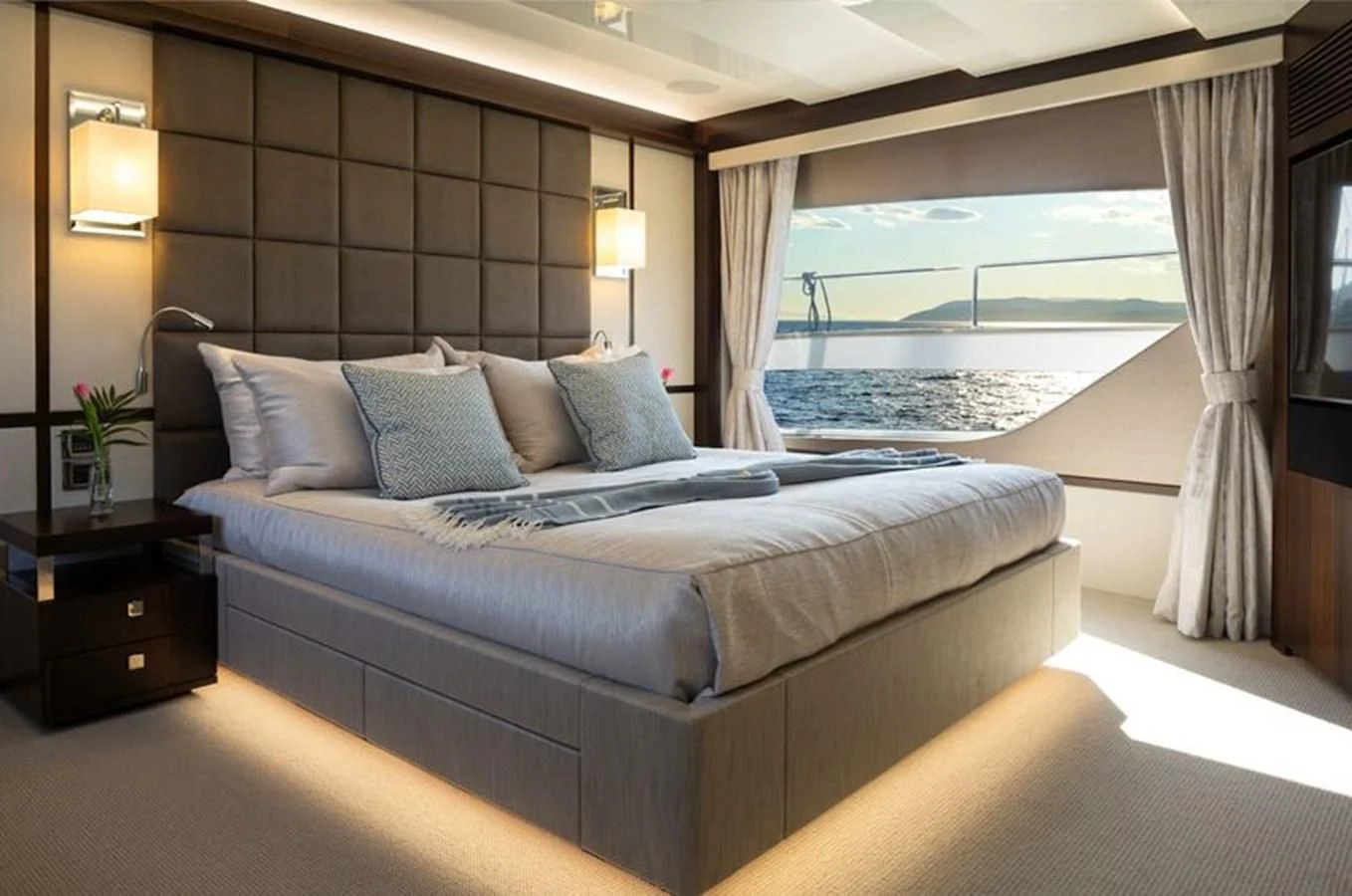 a bed with a large window aboard MR K IRISTON Yacht for Sale