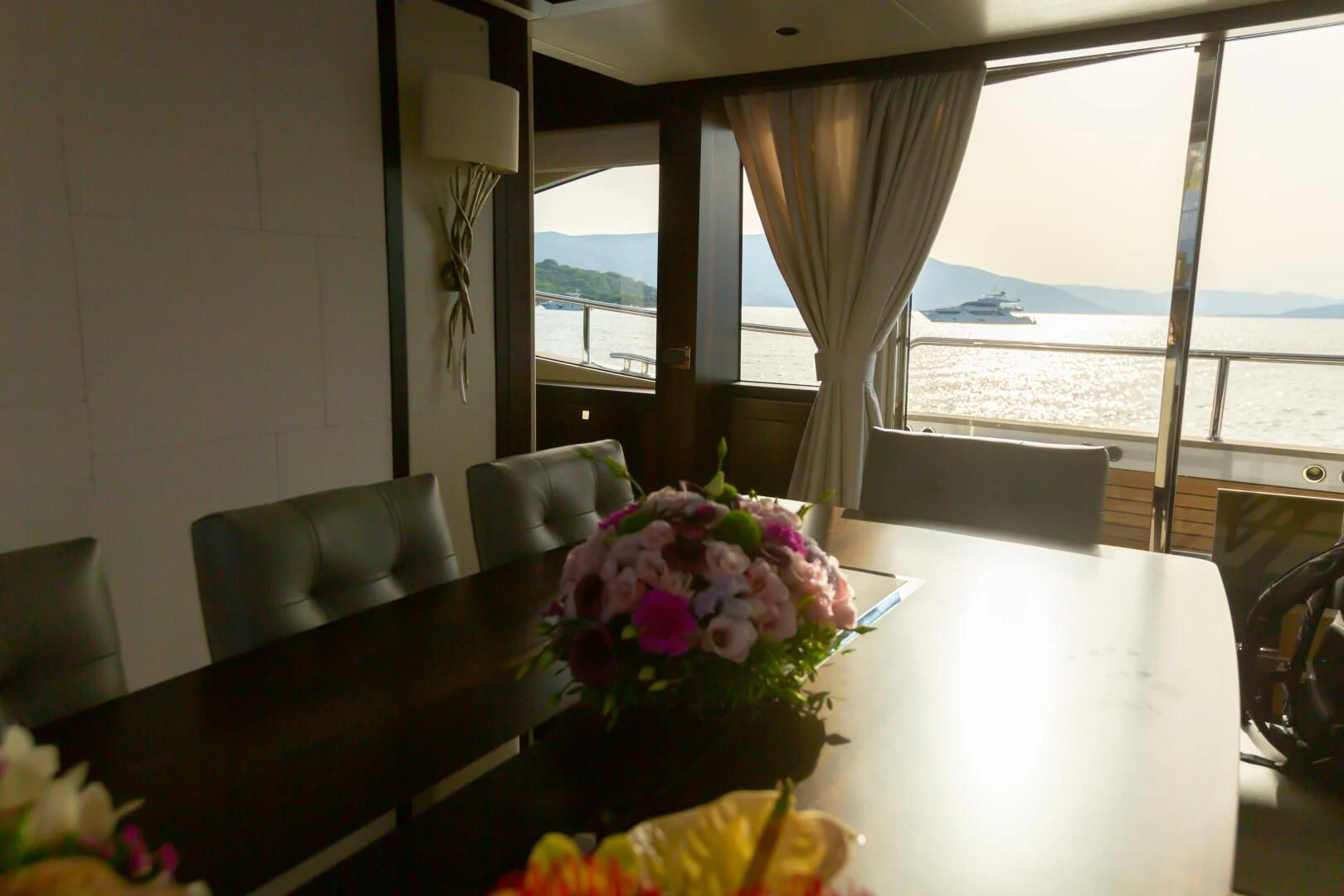 a table with flowers on it aboard MR K IRISTON Yacht for Sale