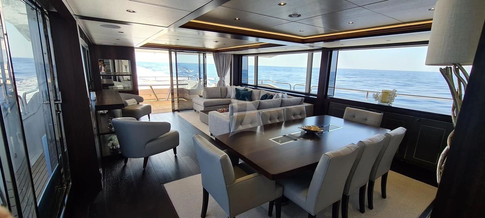 a large room with a table and chairs aboard MR K IRISTON Yacht for Sale