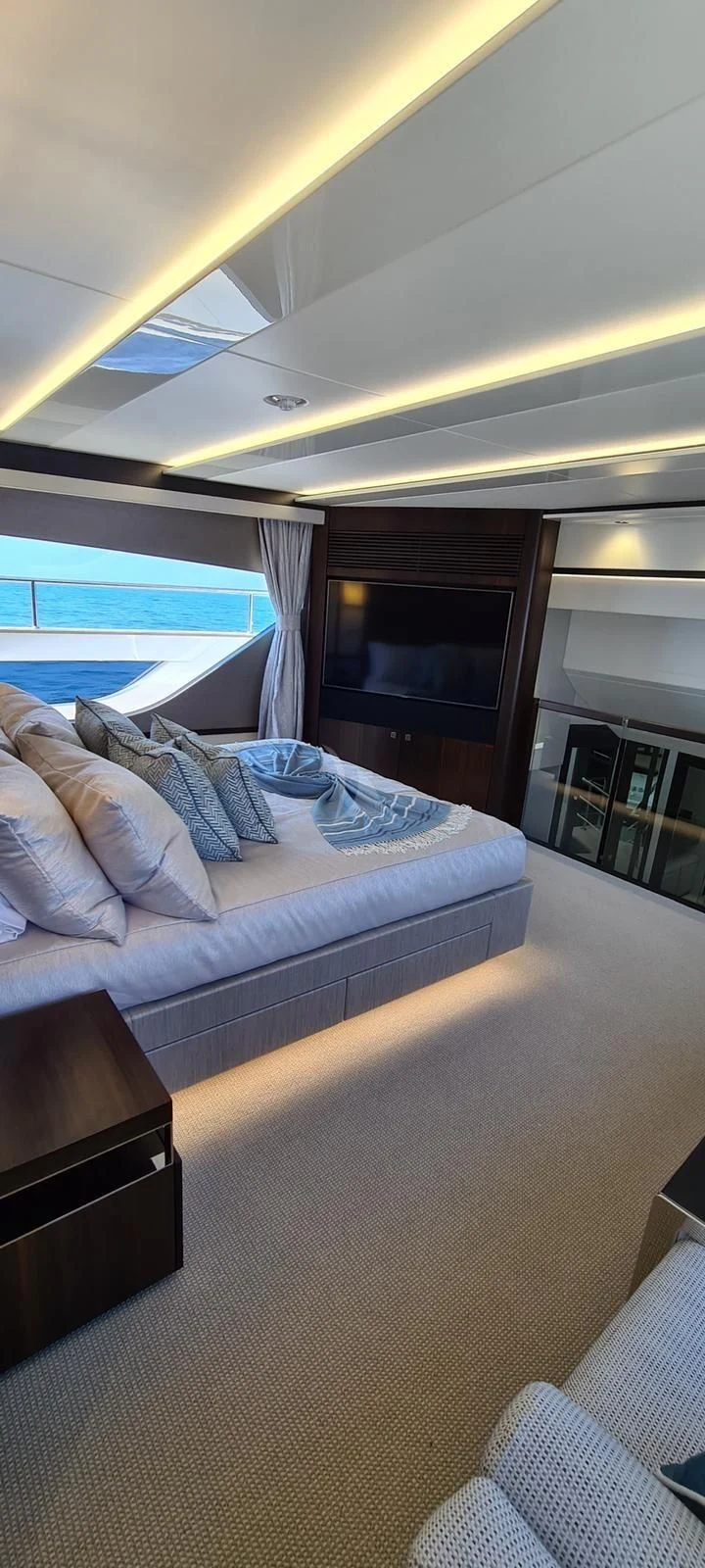 a bed with a blue blanket aboard MR K IRISTON Yacht for Sale