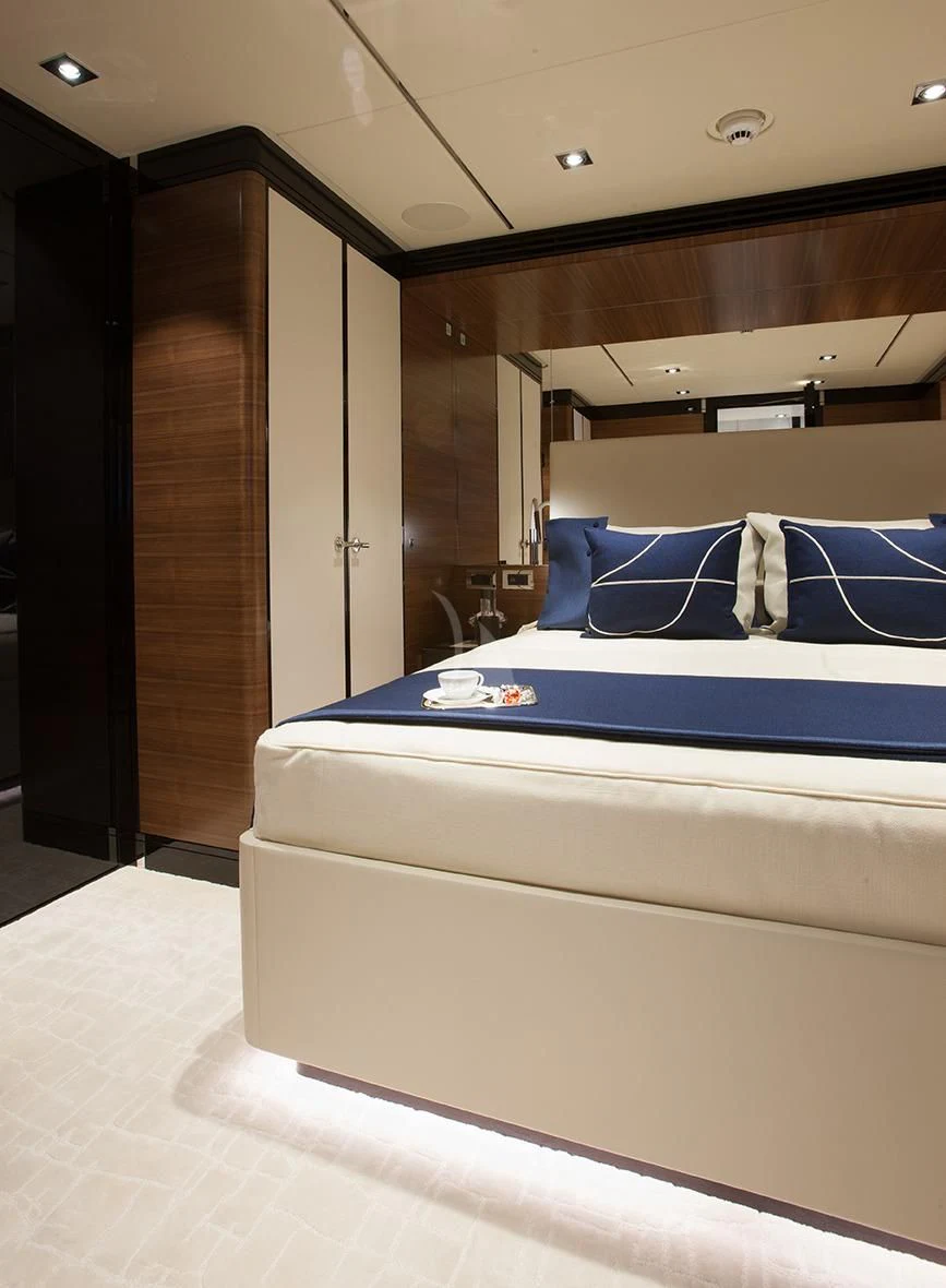 a room with a bed and a wood door aboard DAISY D Yacht for Sale