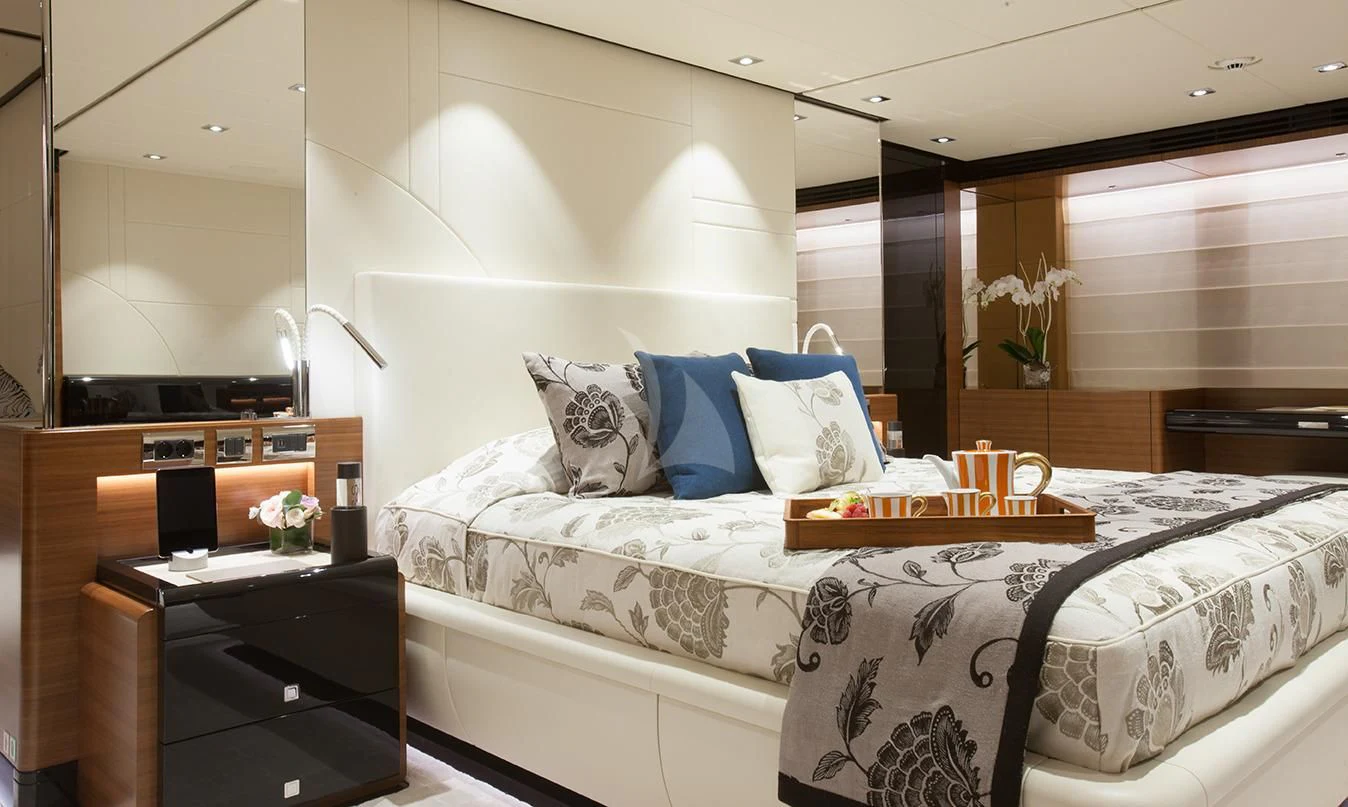 a bed with white sheets and pillows aboard DAISY D Yacht for Sale