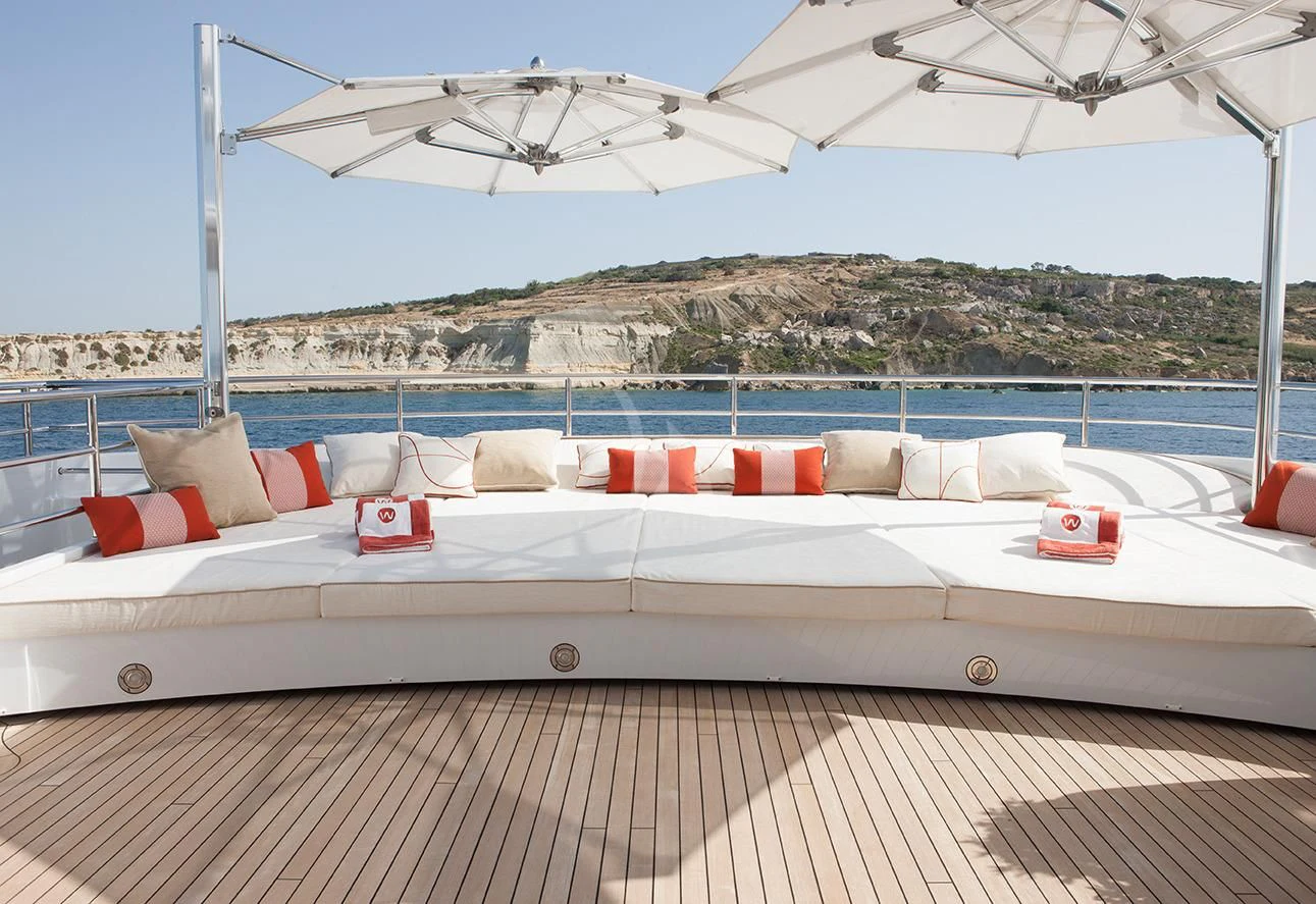 a large white bed with pillows on it aboard DAISY D Yacht for Sale